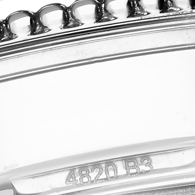 The image shows a close-up of the bezel and part of the case of a Breitling Navitimer A17395 Men's Stainless Steel Pink Dial A17395 Men's Stainless Steel Pink Dial watch, highlighting its intricate detailing.