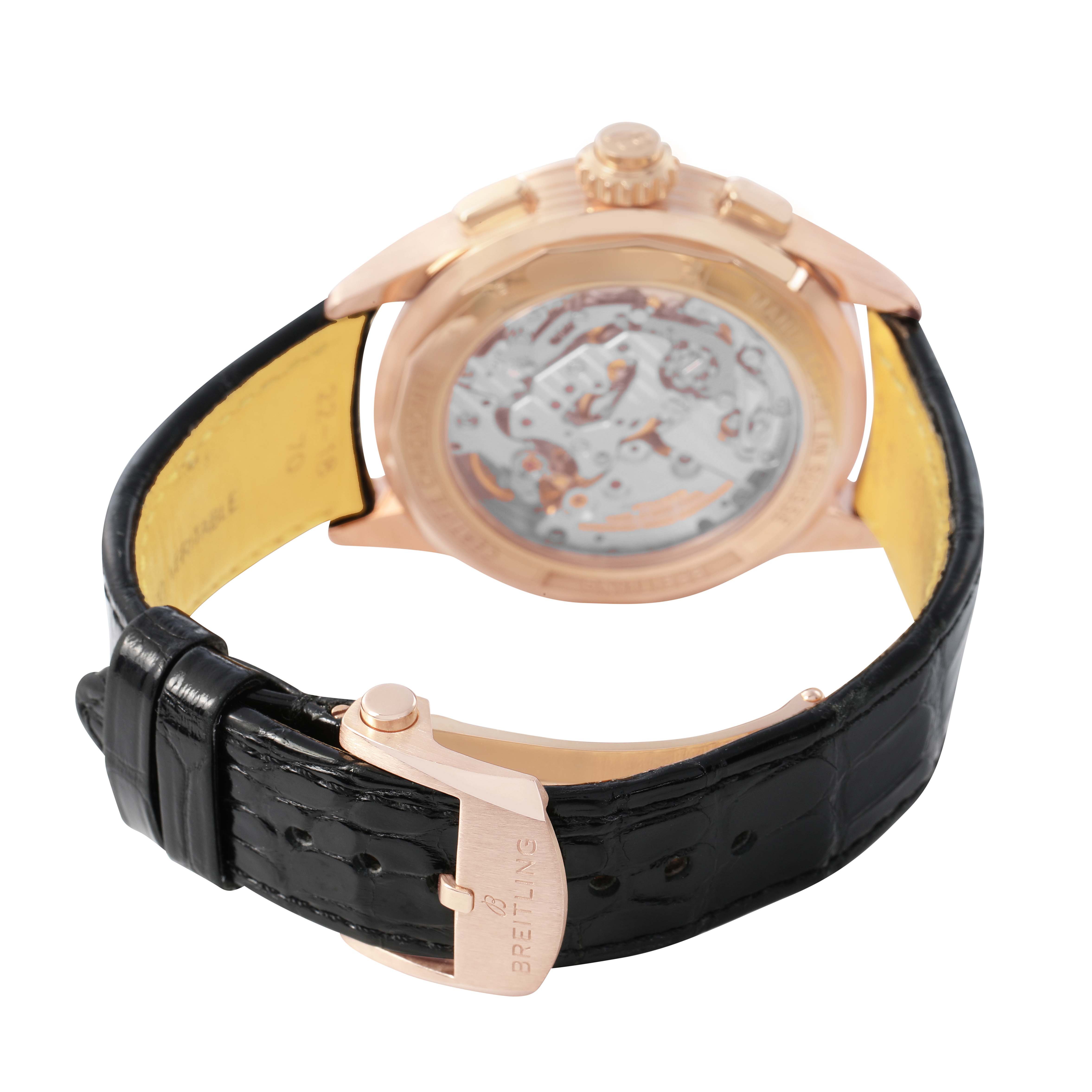 The Breitling Premier RB1510251B1P1 Men's Rose Gold Black Dial watch is shown from the back, highlighting the transparent case back and black leather strap with a branded clasp.