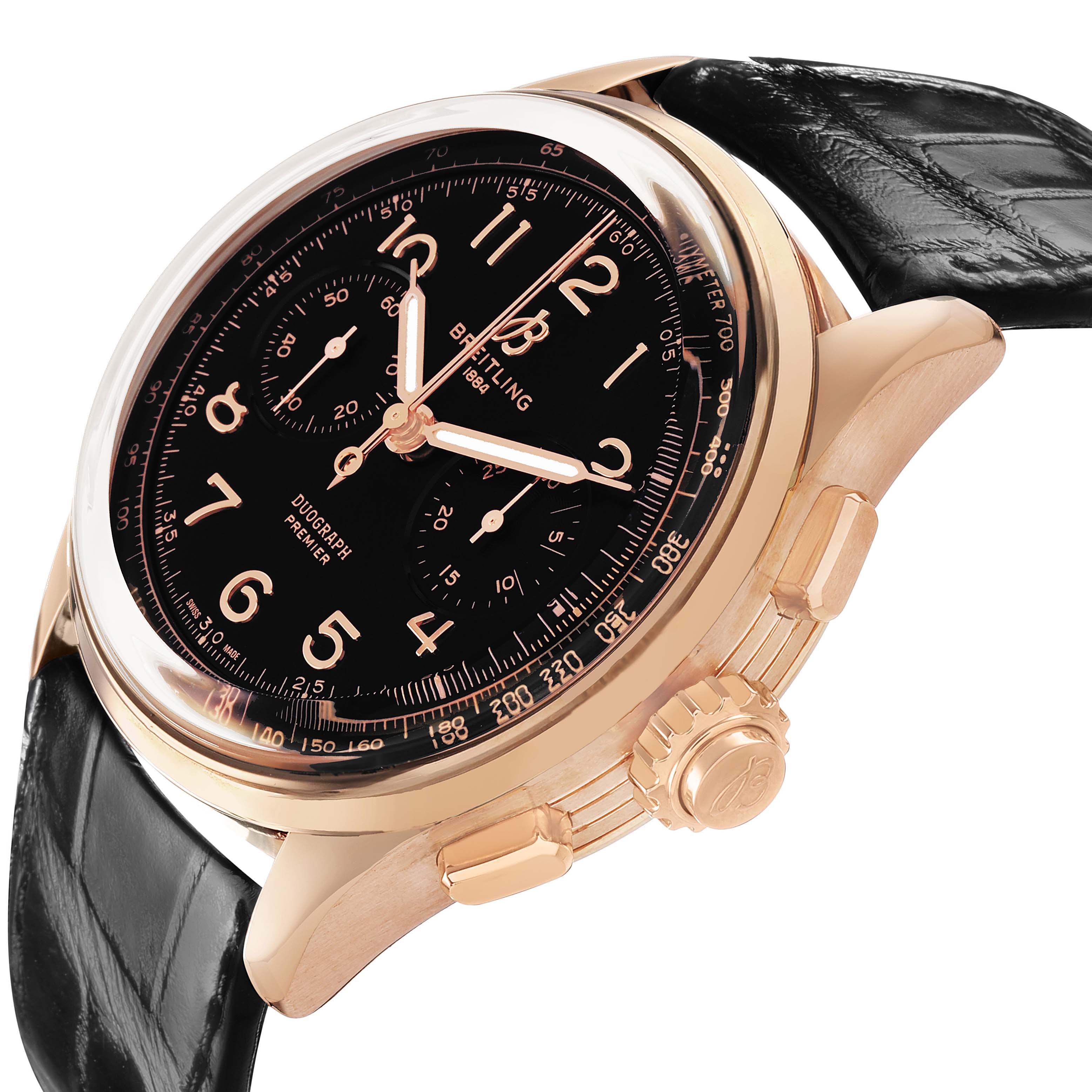 The Breitling Premier RB1510251B1P1 Men's Rose Gold Black Dial watch is shown at an angle highlighting the black dial, gold case, crown, pushers, and black leather strap.