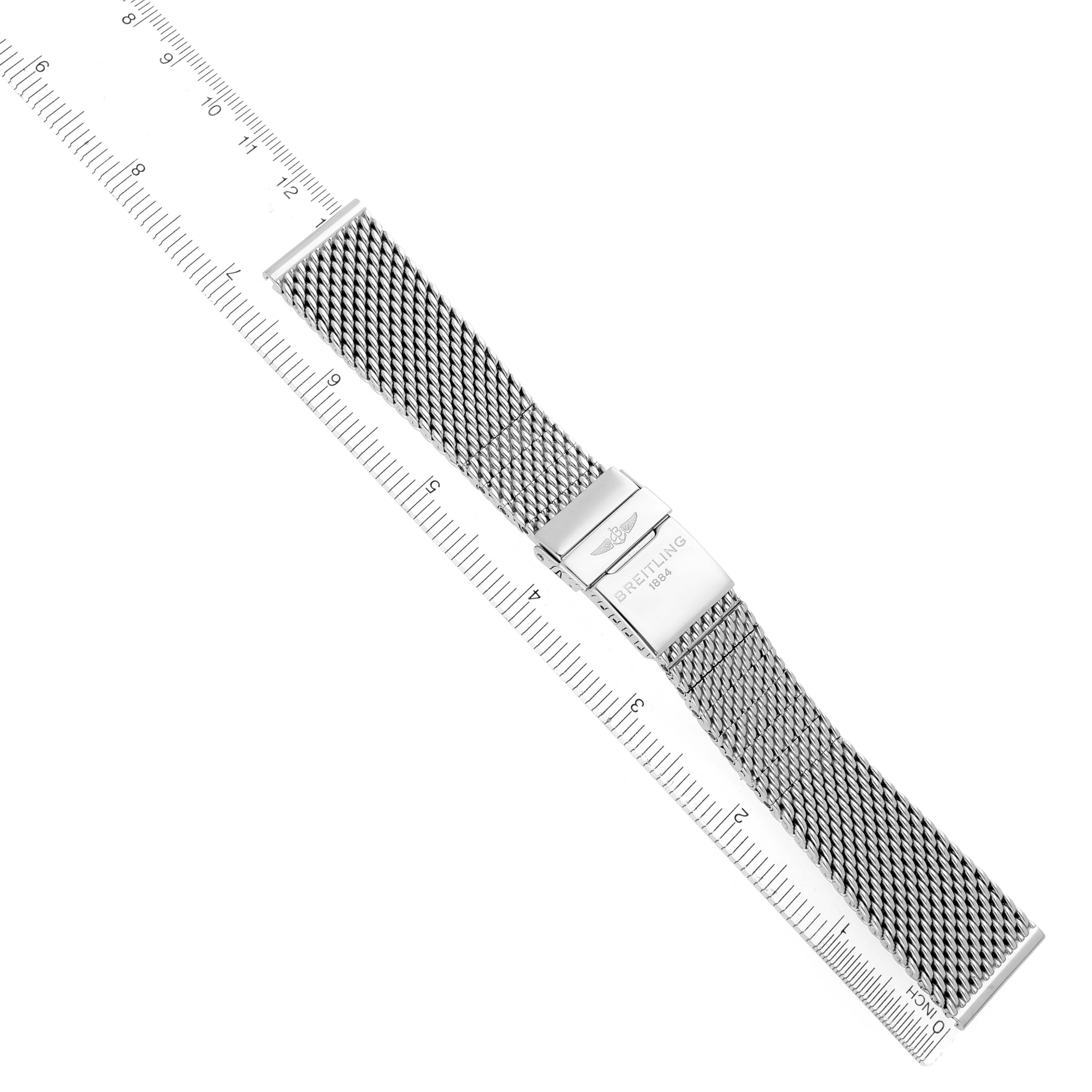 The image shows a Breitling Superocean A17321 Men's Stainless Steel Silver Dial A17321 Men's Stainless Steel Silver Dial mesh bracelet with a clasp, photographed from above alongside a ruler.