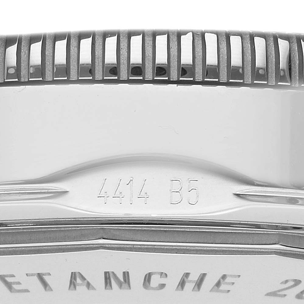 The image shows a close-up of the side of a Breitling Superocean A17321 Men's Stainless Steel Silver Dial A17321 Men's Stainless Steel Silver Dial watch, focusing on the case edge and engraving.