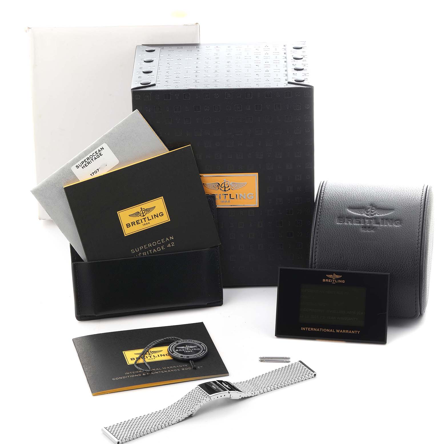The image shows the accessories and packaging of the Breitling Superocean A17321 Men's Stainless Steel Silver Dial A17321 Men's Stainless Steel Silver Dial model, including boxes, booklets, and a metal bracelet.