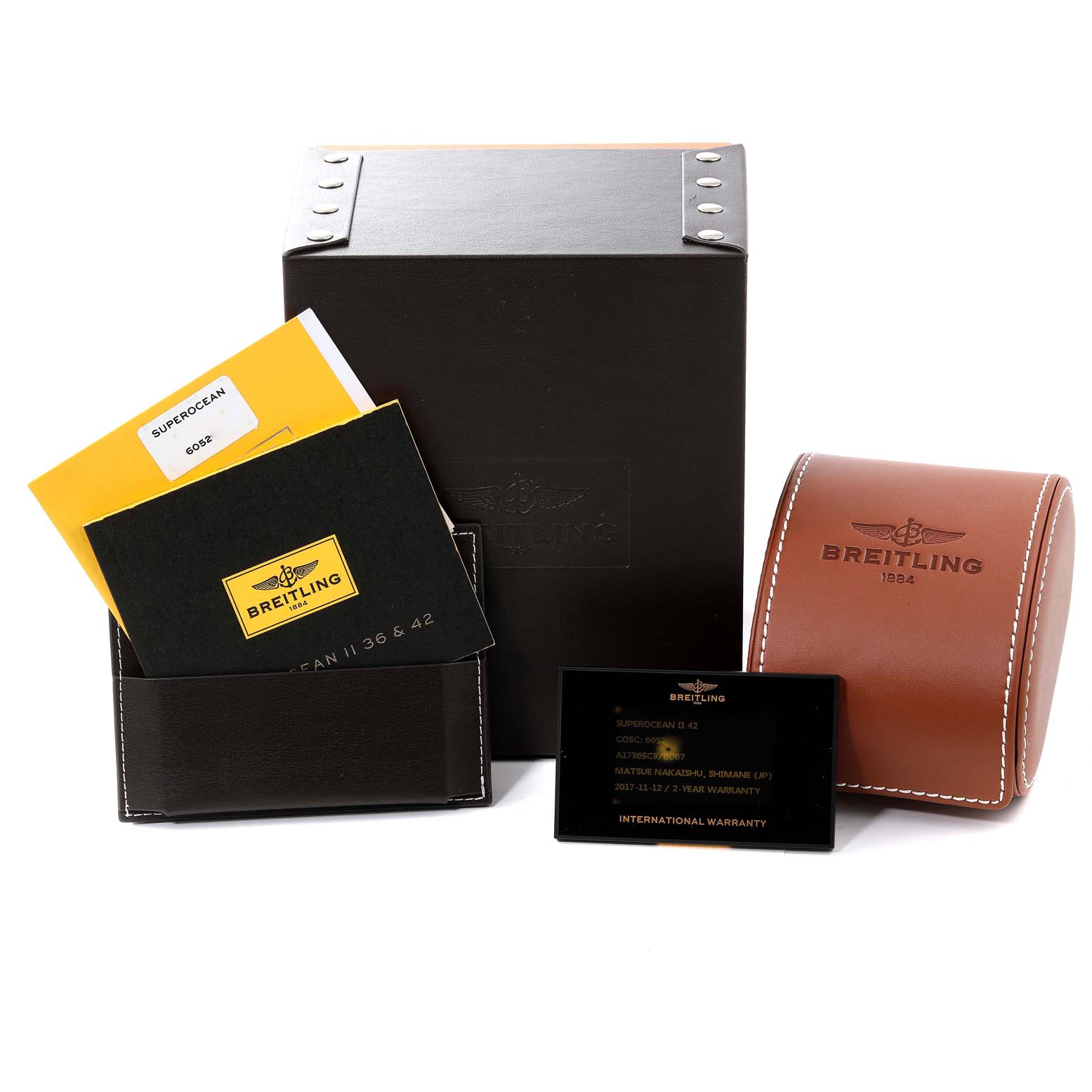 The image shows packaging and accessories for the Breitling Superocean A17365 Men's Stainless Steel Black Dial A17365 Men's Stainless Steel Black Dial watch, including booklets, warranty card, and a watch case.