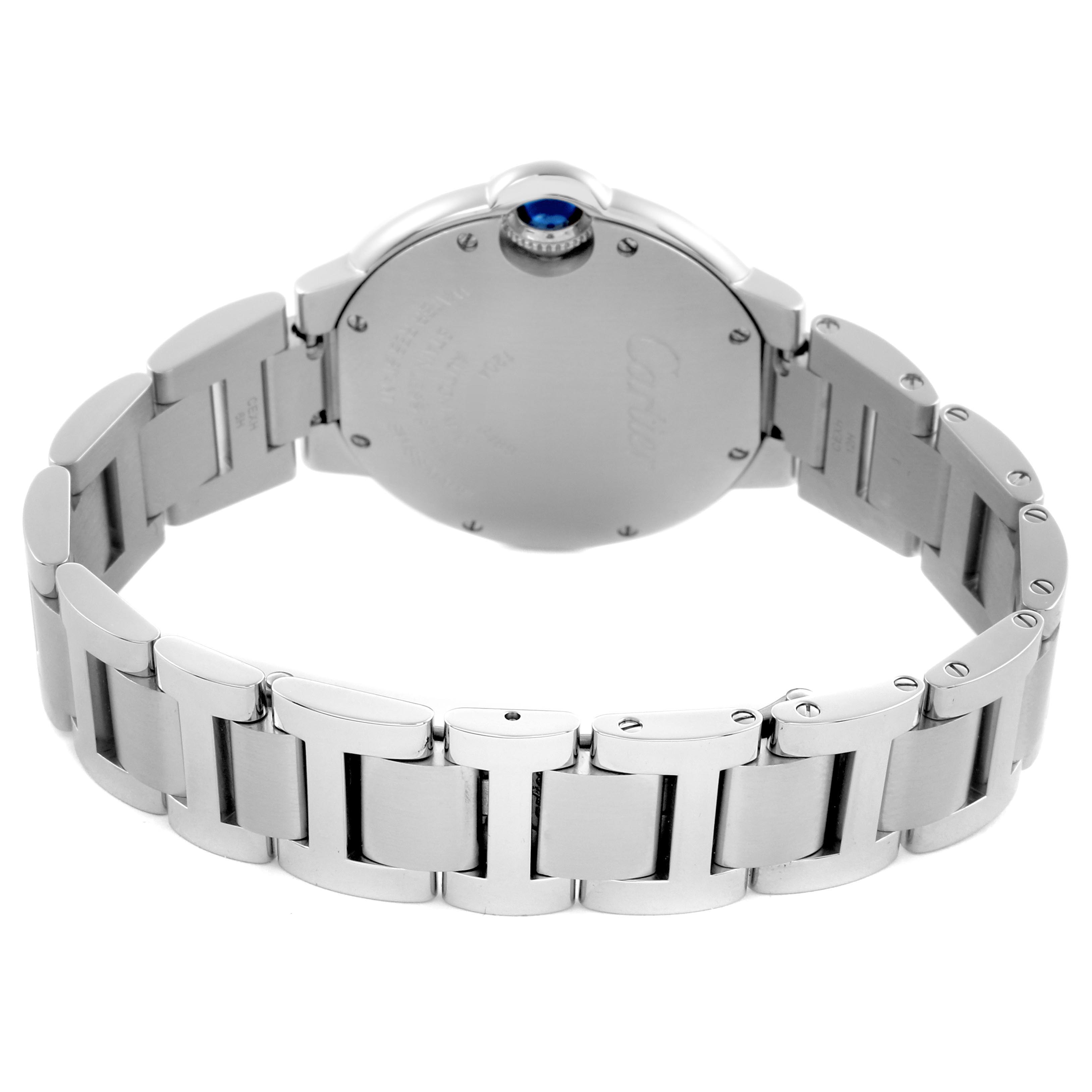 The image shows the back and bracelet of the Ballon Bleu by Cartier, highlighting the metal links and crown from a rear angle.