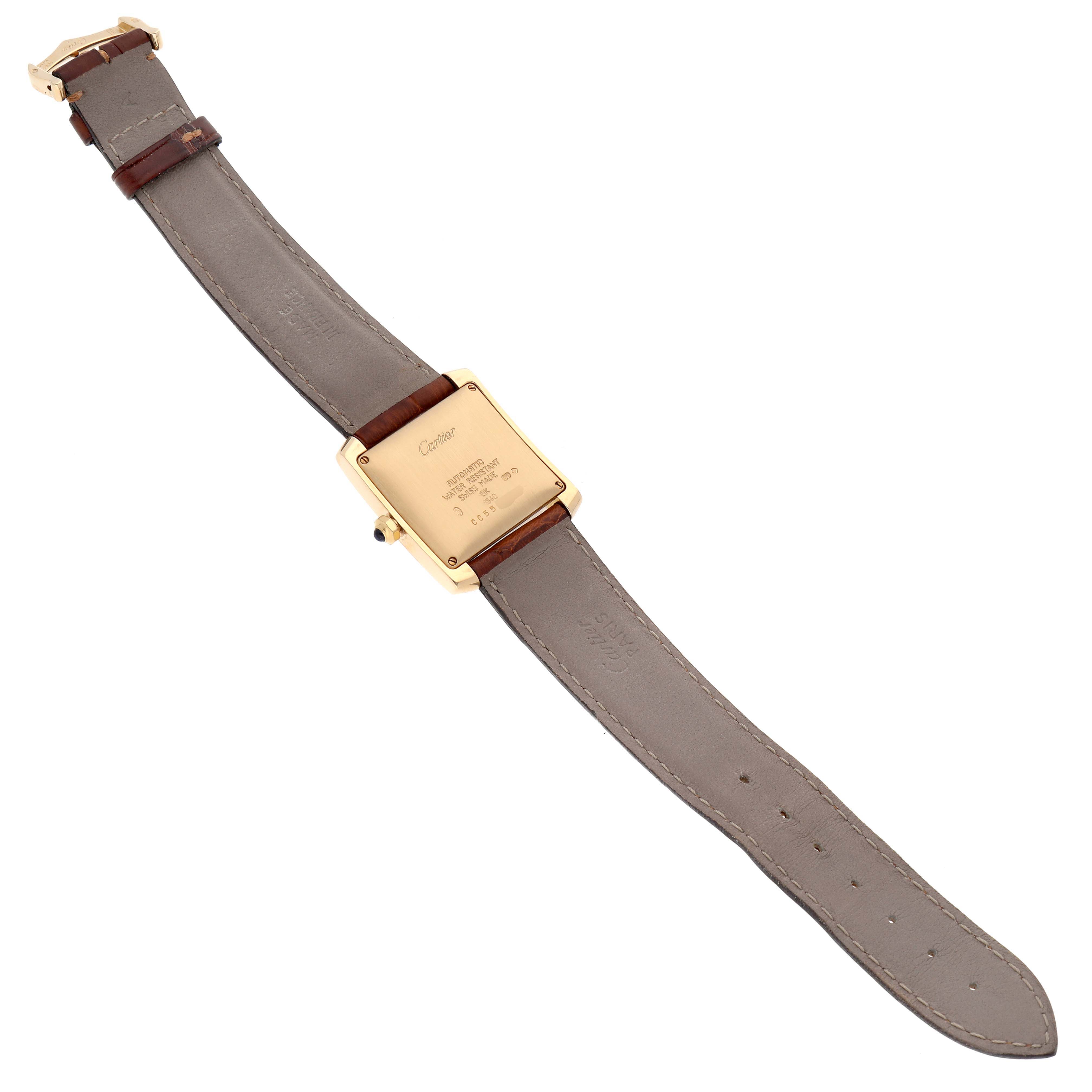 The image shows the back view of a Cartier Tank Francaise W5000156 Men
s Yellow Gold Silver Dial W5000156 Men
s Yellow Gold Silver Dial watch, highlighting the back case and leather strap.