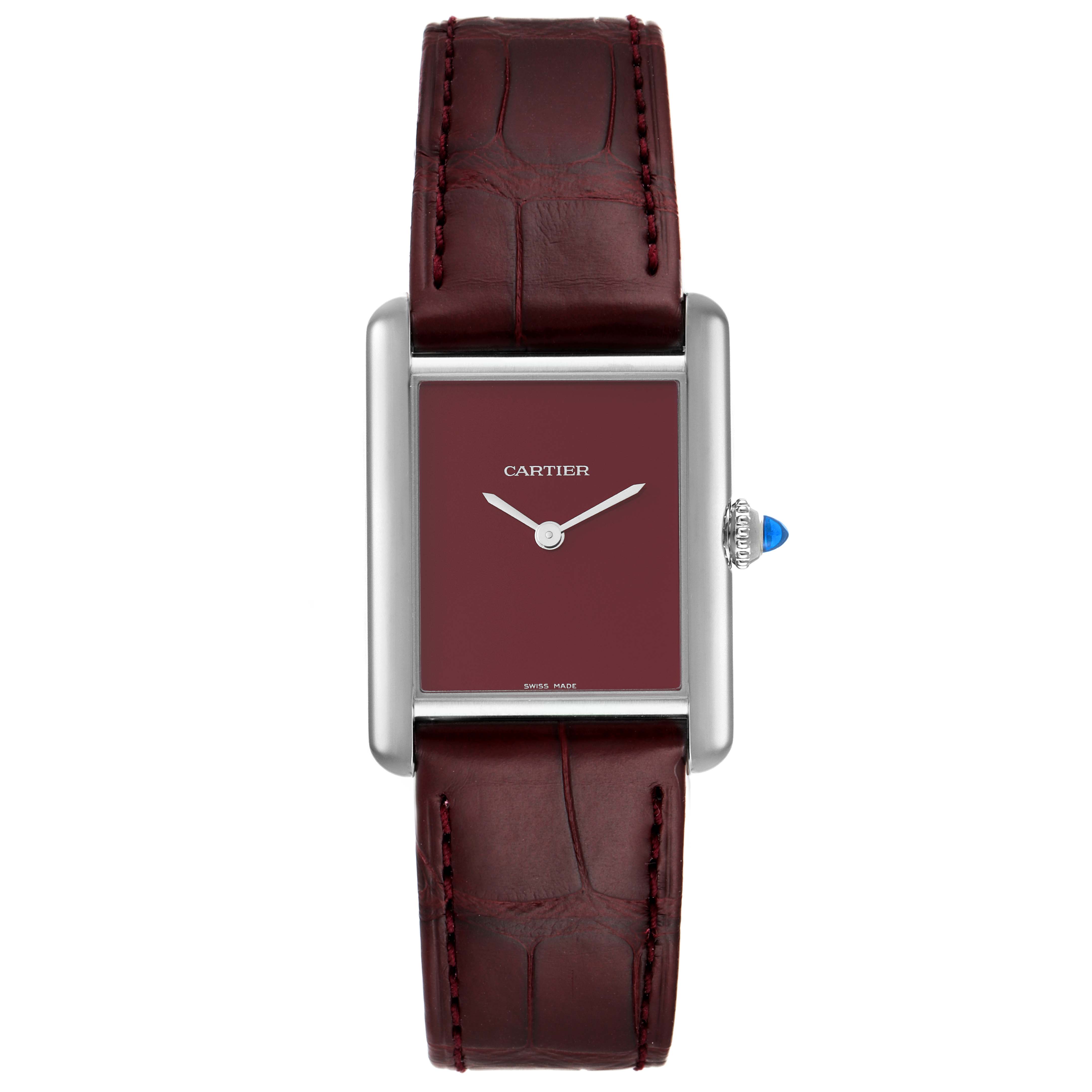 The image shows a front view of the Cartier Tank Must WSTA0054 Women's Stainless Steel Red Dial WSTA0054 Women's Stainless Steel Red Dial watch, highlighting its square case, burgundy dial, and leather strap.