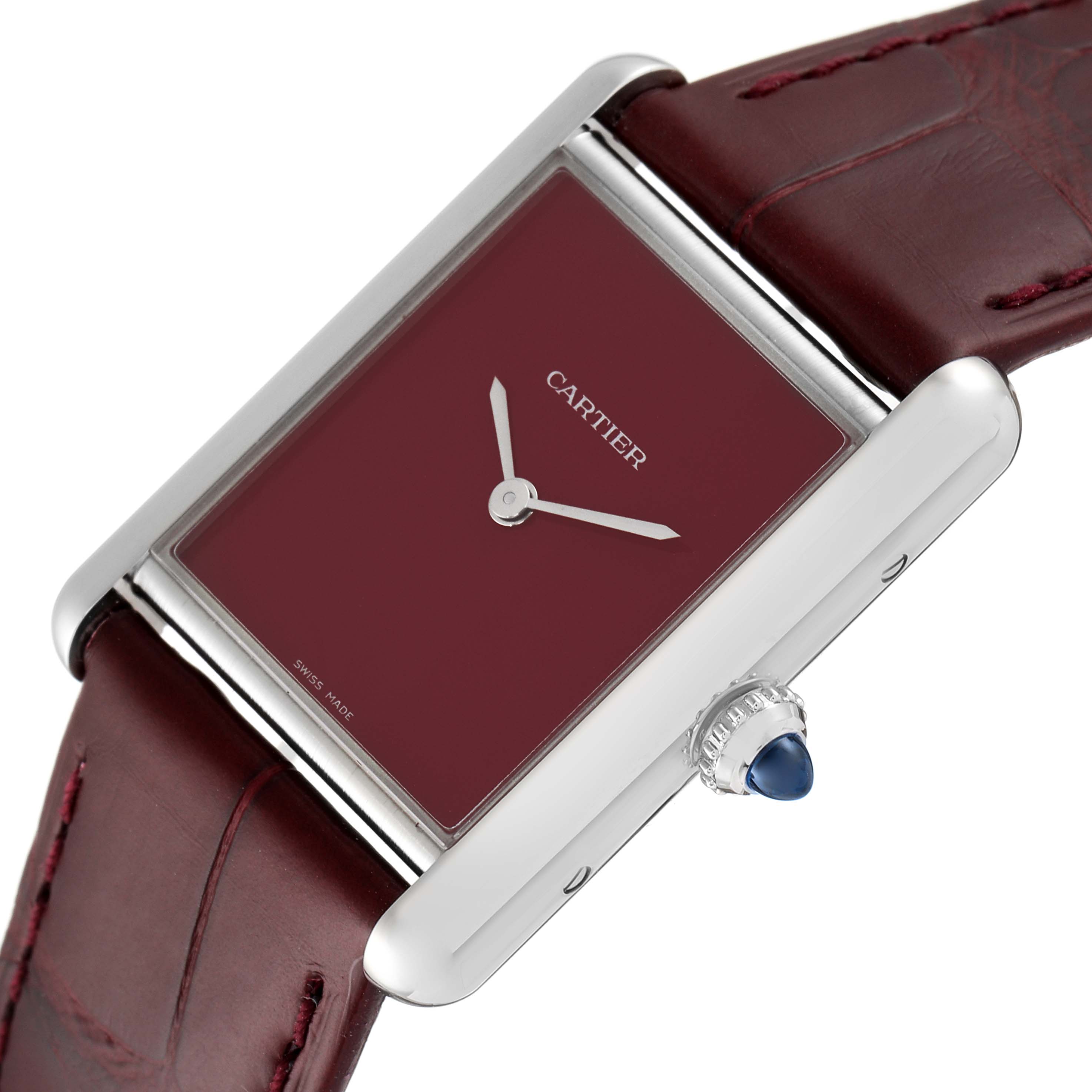 The Cartier Tank Must WSTA0054 Women's Stainless Steel Red Dial WSTA0054 Women's Stainless Steel Red Dial watch is shown at an angle highlighting its face, crown, and leather strap.