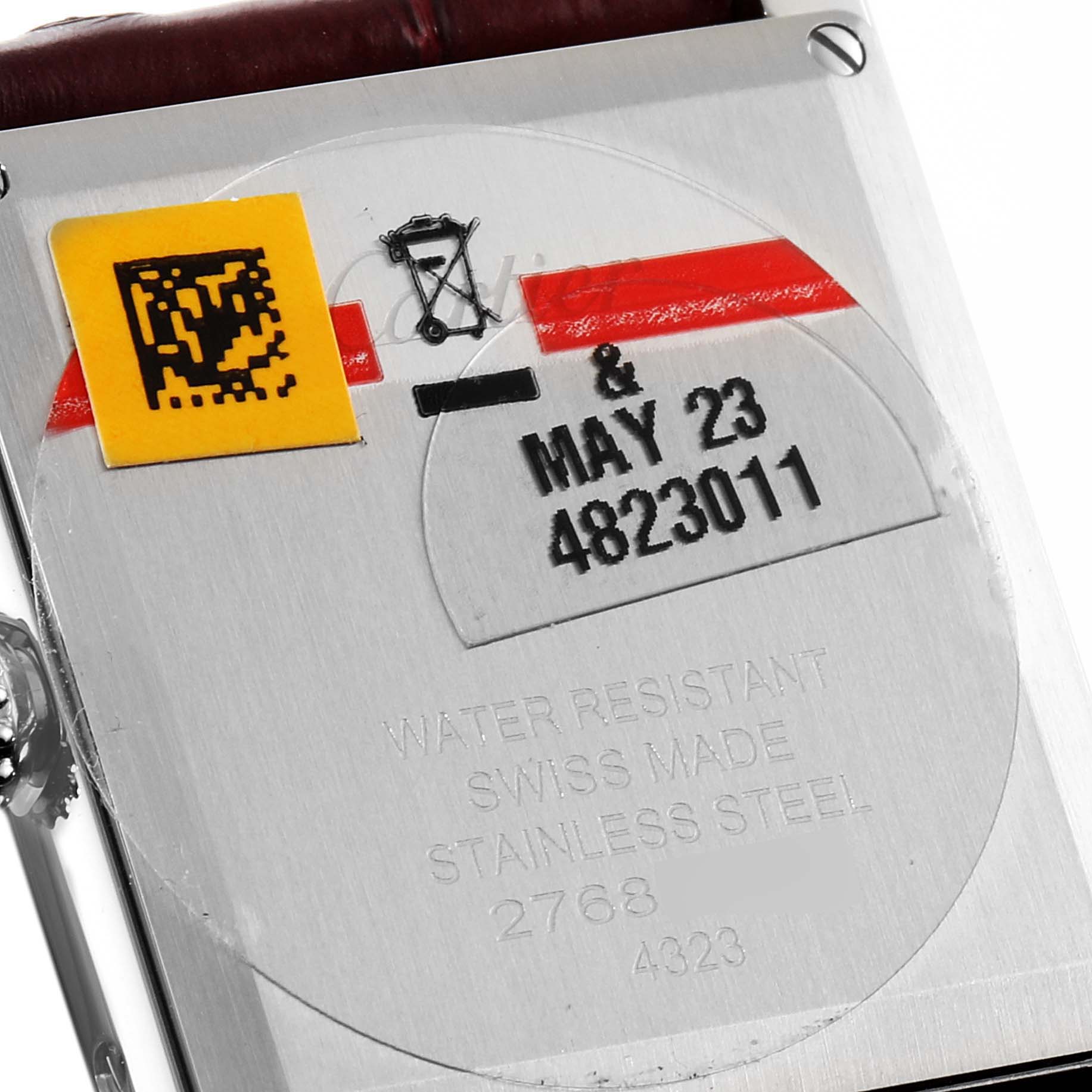 This image shows the back case of a Cartier Tank Must WSTA0054 Women's Stainless Steel Red Dial WSTA0054 Women's Stainless Steel Red Dial watch, displaying its water resistance, Swiss origin, and stainless steel material.