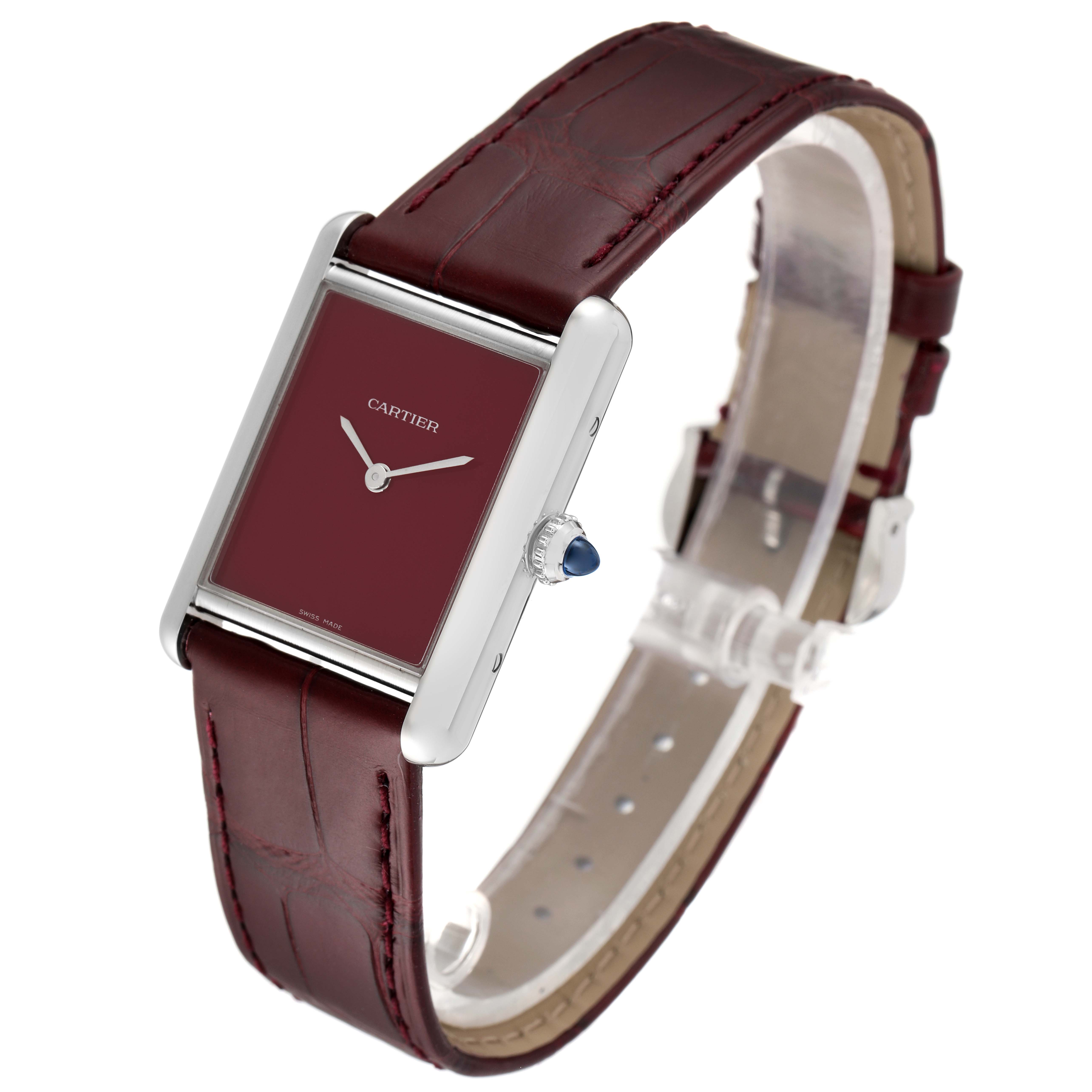 The image shows a Cartier Tank Must WSTA0054 Women's Stainless Steel Red Dial WSTA0054 Women's Stainless Steel Red Dial watch at an angled view, highlighting its rectangular face and burgundy leather strap.