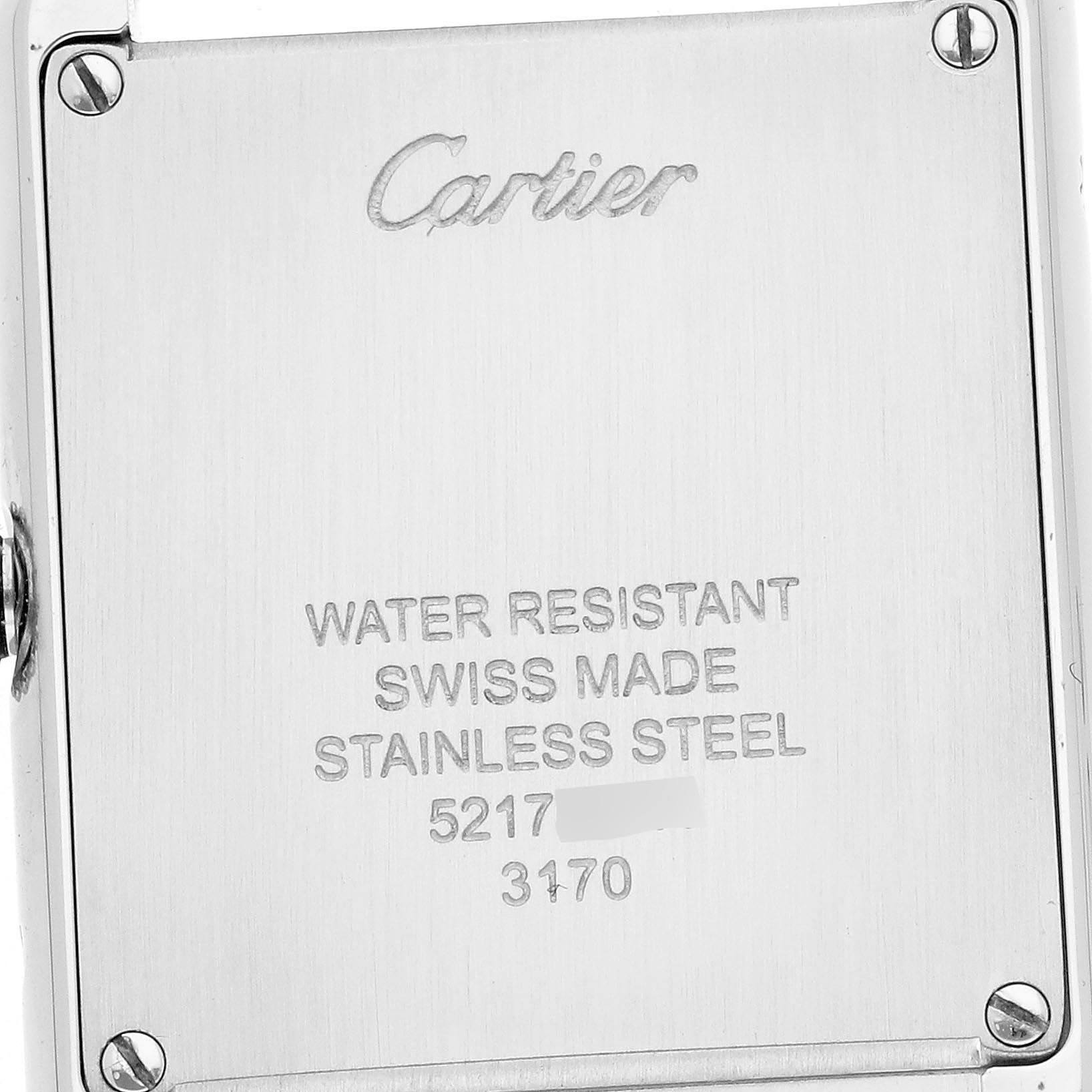The image shows the back of a Tank Solo by Cartier, highlighting the engraving details and corner screws.