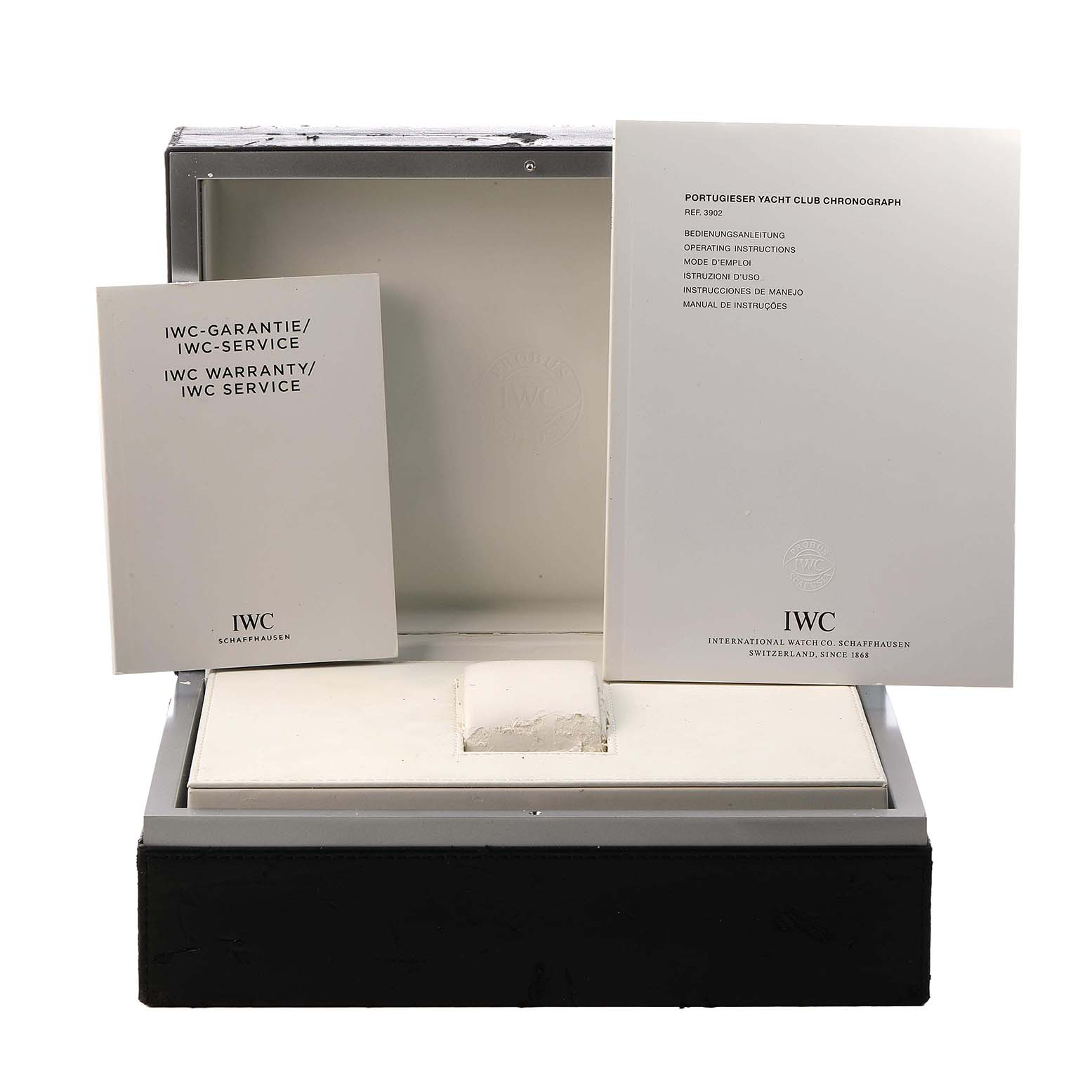 The image shows the open box and manuals for an IWC Portuguese IW390211 Men's Stainless Steel Silver Dial model watch, highlighting the warranty and instructions.