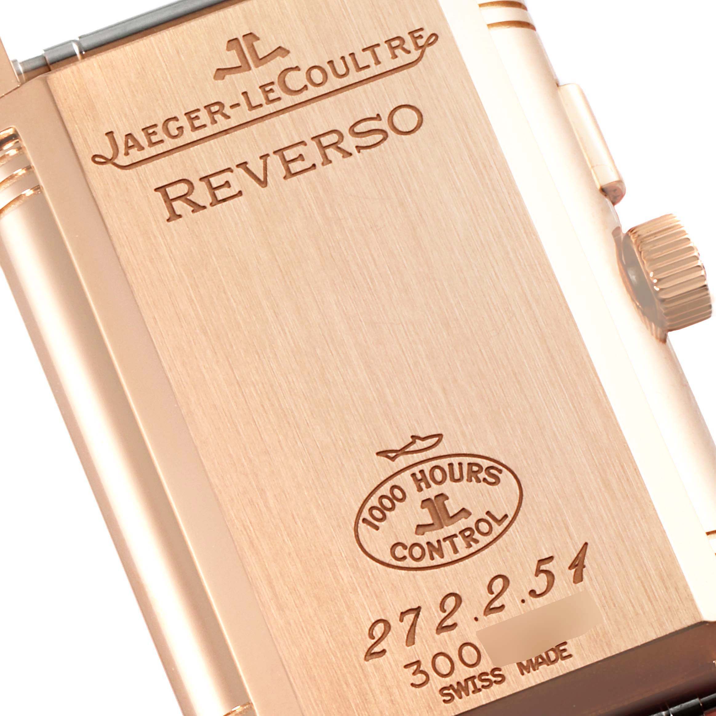 The image shows the back case of a Jaeger-LeCoultre Reverso watch, highlighting the model details and manufacturer's engravings.