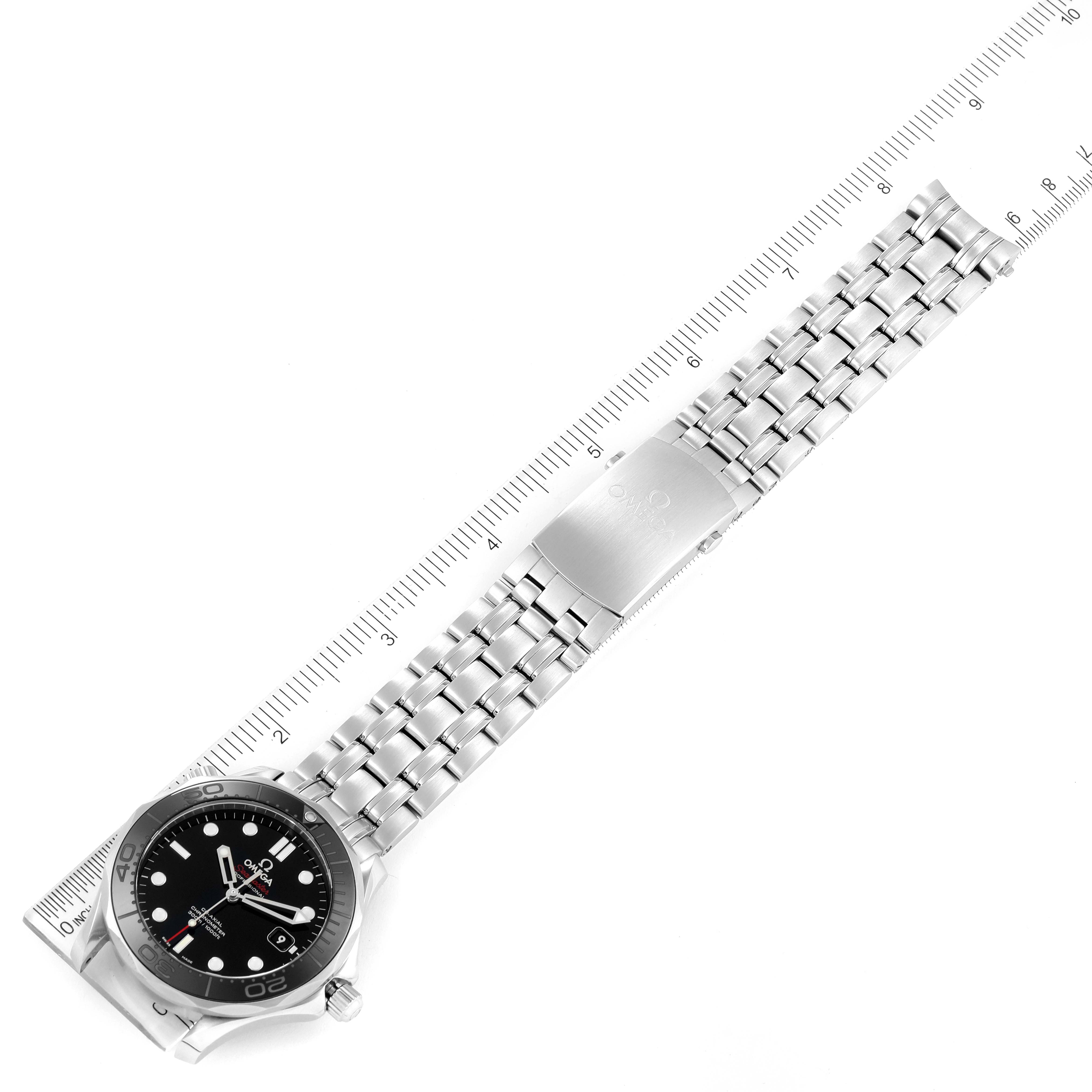 The Omega Seamaster 212.30.41.20.01.003 Men's Stainless Steel Black Dial 212.30.41.20.01.003 Men's Stainless Steel Black Dial watch is photographed from above, displaying its face, bezel, crown, and stainless steel bracelet alongside a ruler.