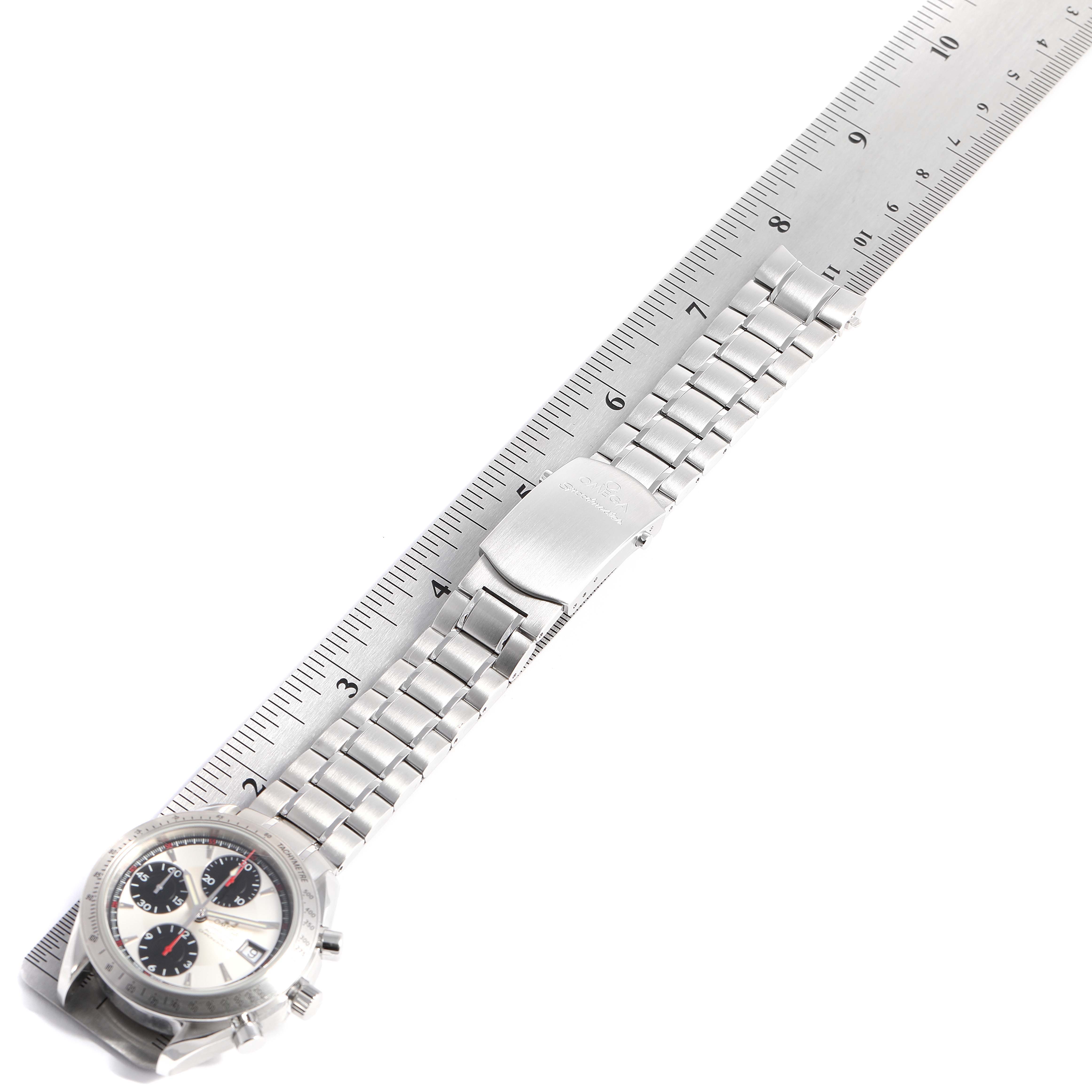 The Omega Speedmaster 3211.31.00 Men's Stainless Steel Silver Dial 3211.31.00 Men's Stainless Steel Silver Dial watch shown at an angle highlights the clasp and part of the metal bracelet against a ruler.