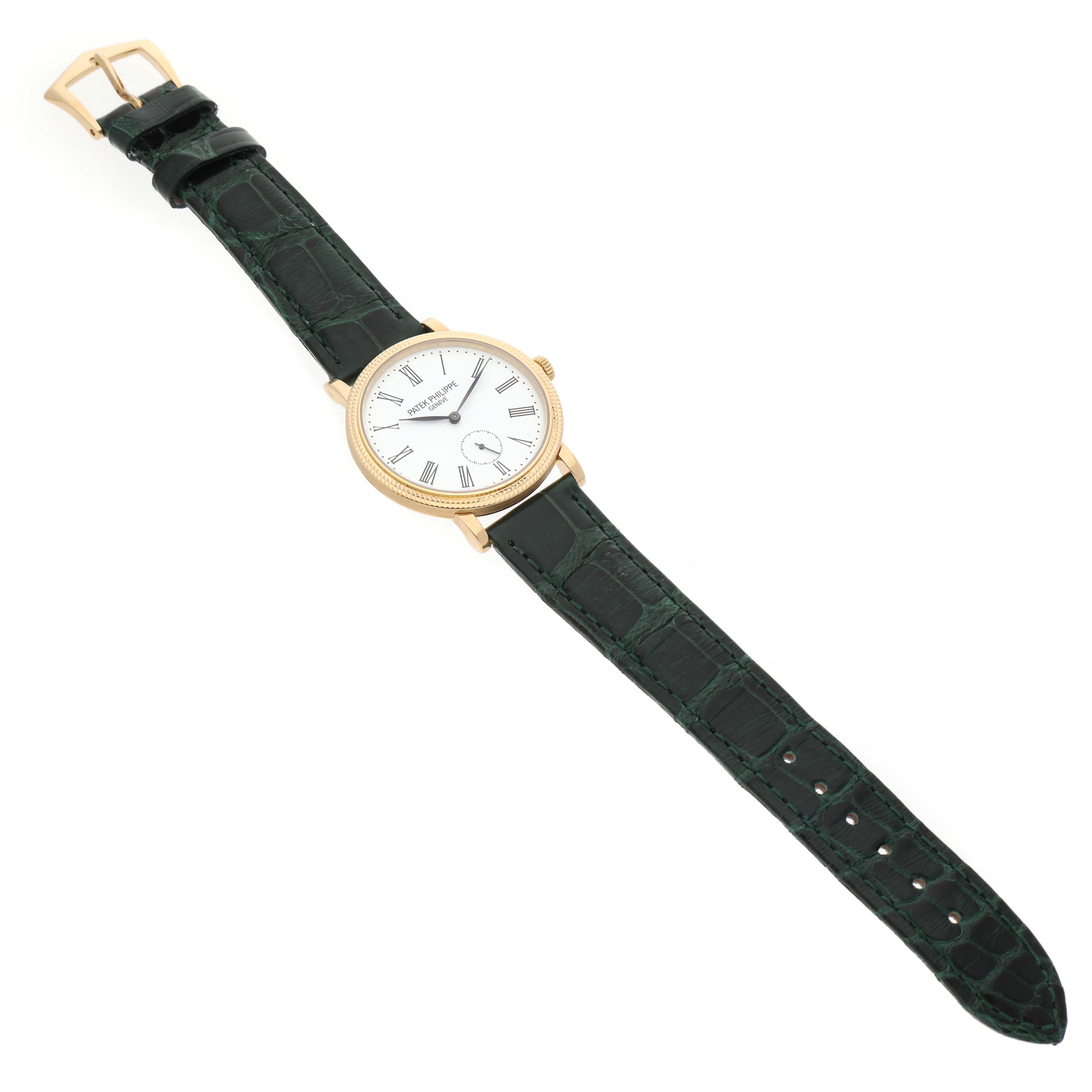 The Patek Philippe Calatrava 7119 / 7119J Women's Yellow Gold White Dial watch is shown from a top-down angle, displaying its face, bezel, case, and full strap.