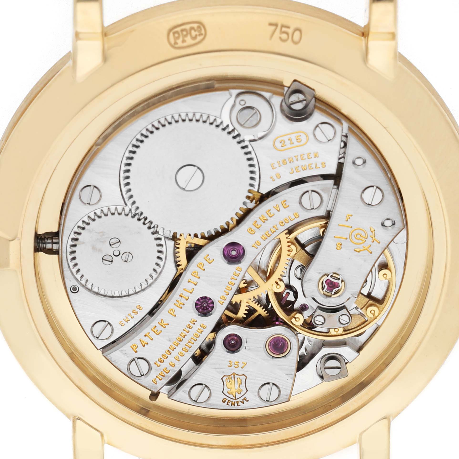 The image shows the back of a Patek Philippe Calatrava 7119 / 7119J Women's Yellow Gold White Dial watch, revealing its intricate movement and internal mechanics.