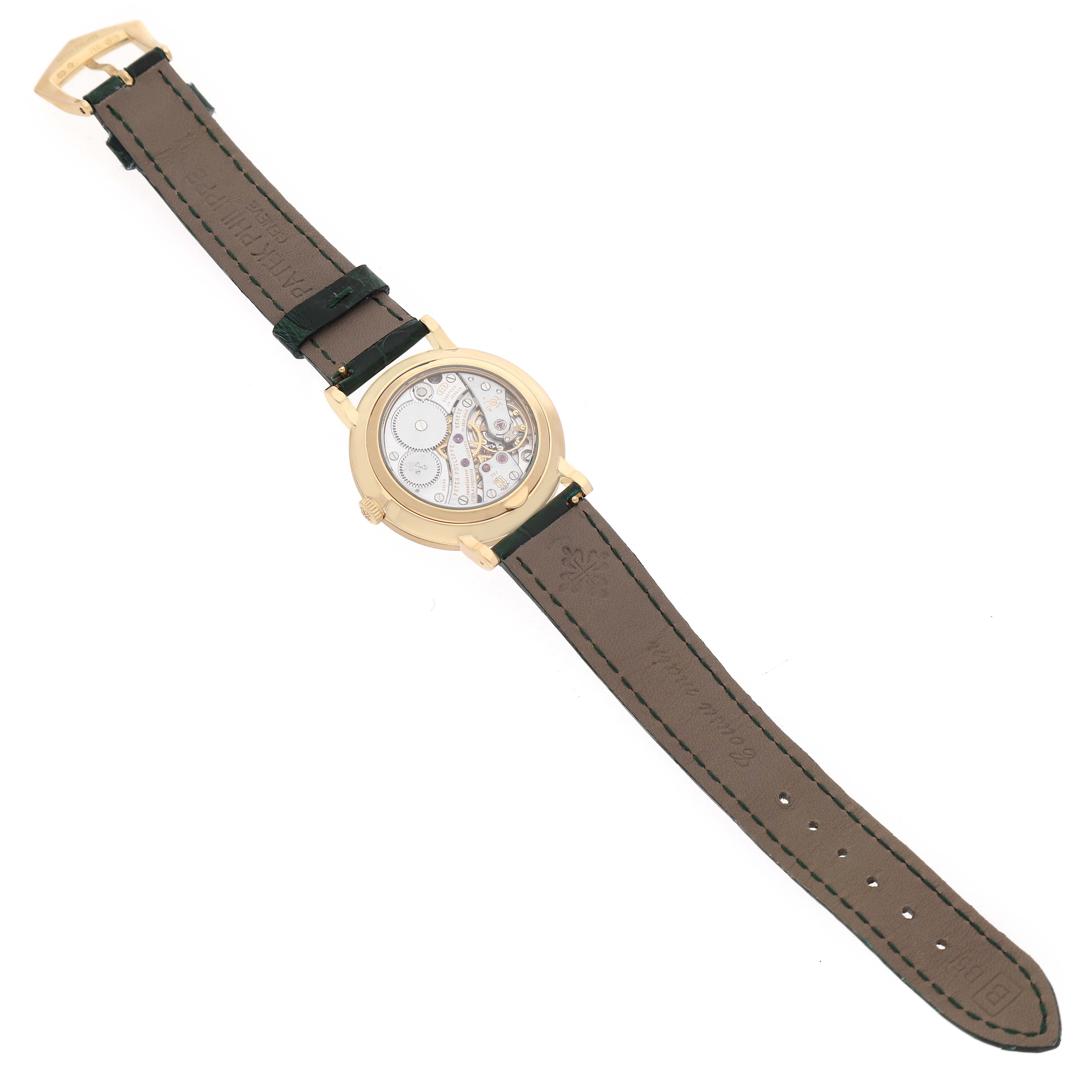 The image shows a Patek Philippe Calatrava 7119 / 7119J Women's Yellow Gold White Dial watch from the back, highlighting the exposed movement and leather strap.