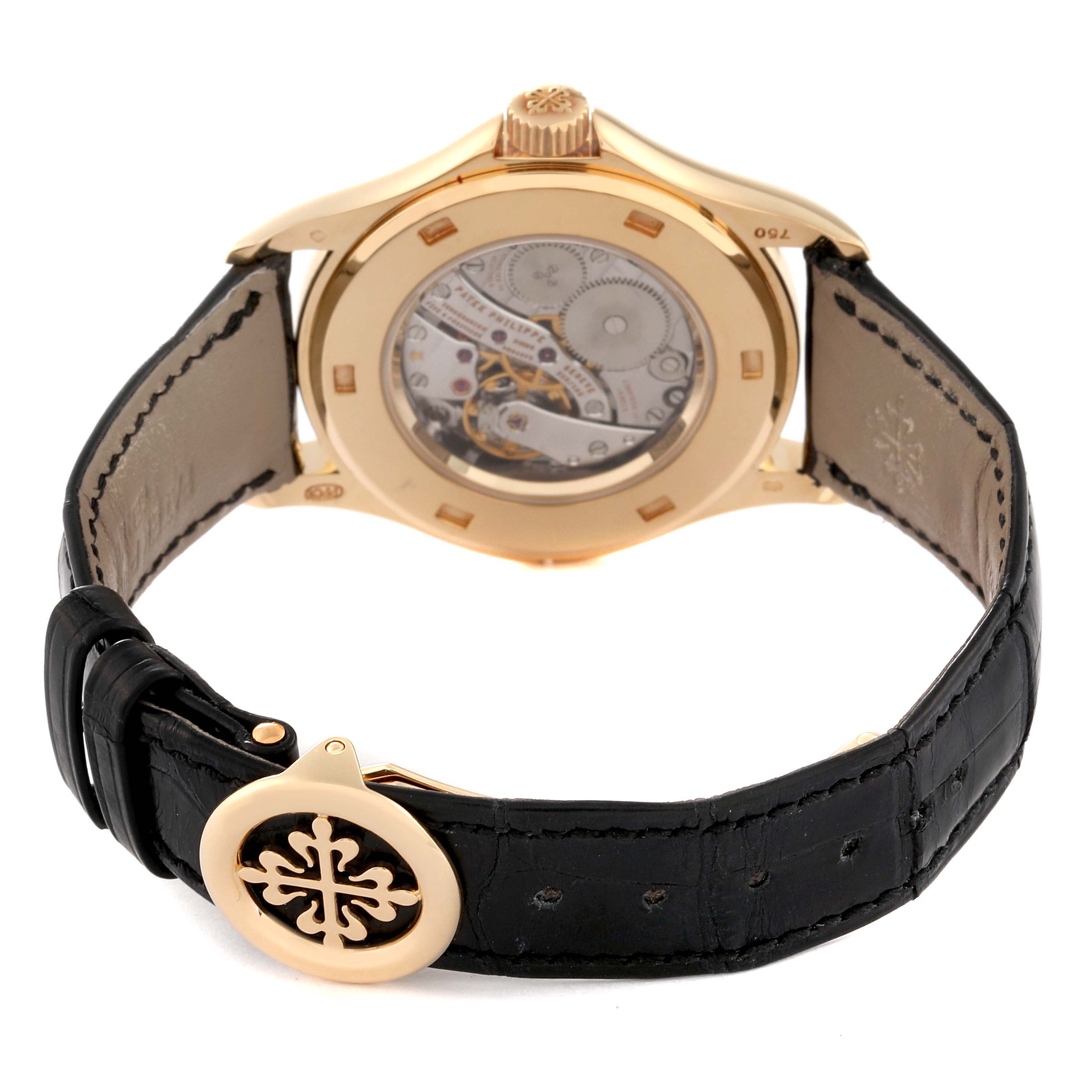 The image shows the back view of a Patek Philippe Calatrava 5134J Men's Yellow Gold Silver Dial 5134J Men's Yellow Gold Silver Dial watch, highlighting its movement and leather strap with a clasp.