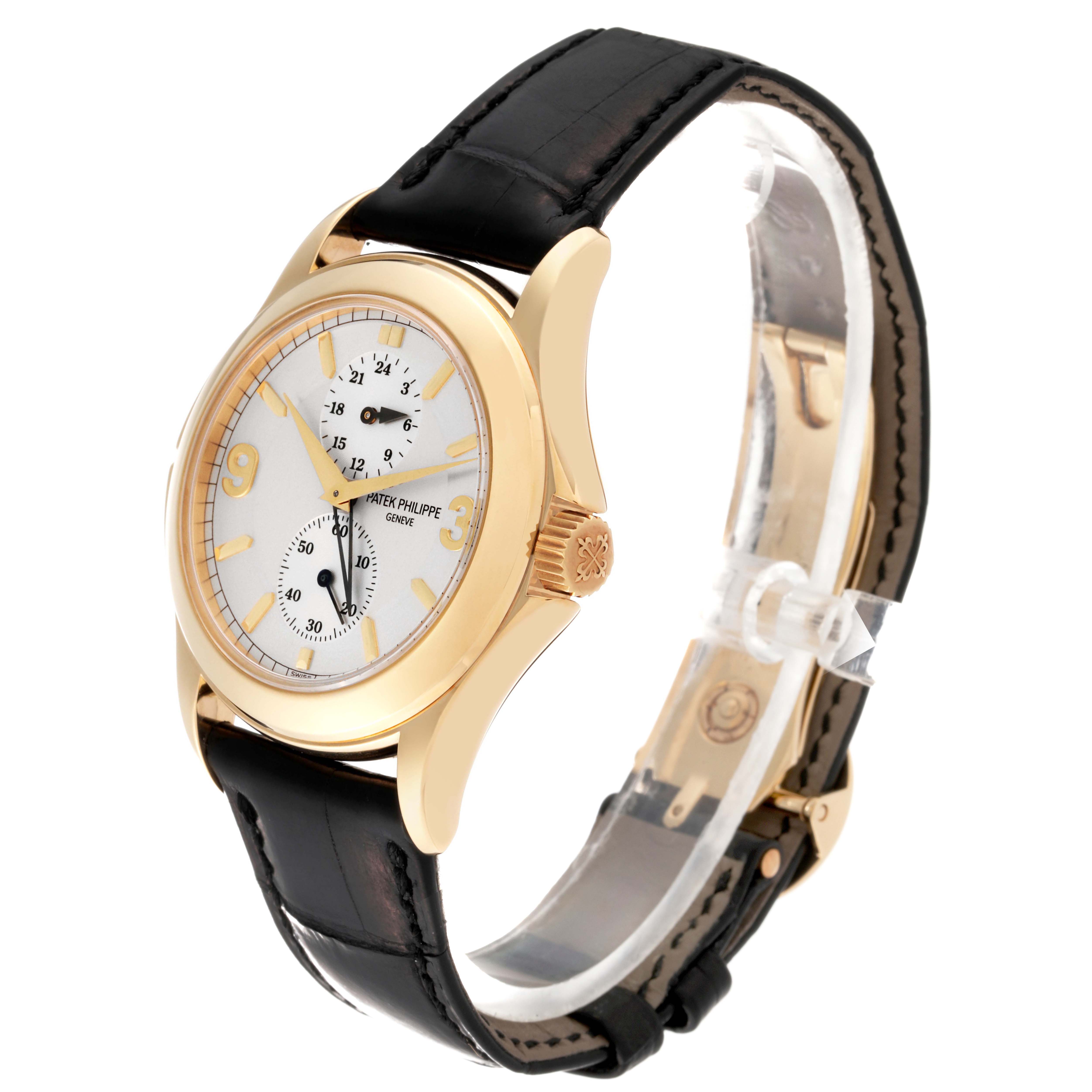 This image shows a Patek Philippe Calatrava 5134J Men's Yellow Gold Silver Dial 5134J Men's Yellow Gold Silver Dial watch at an angled side view, highlighting the dial, case, and strap.