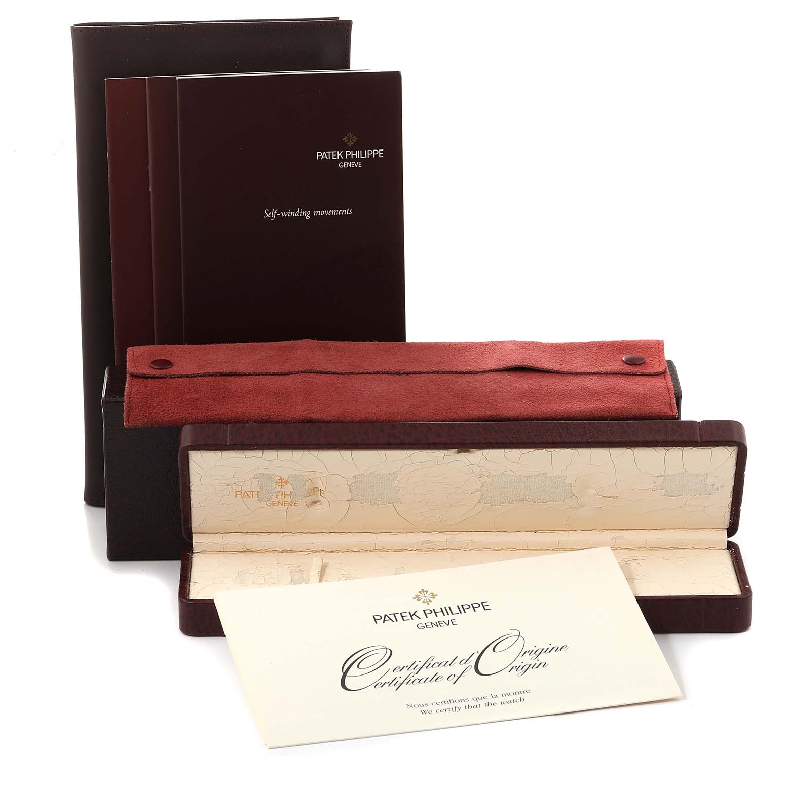 The image shows the packaging, manual, and certificate of origin for the Calatrava model by Patek Philippe.