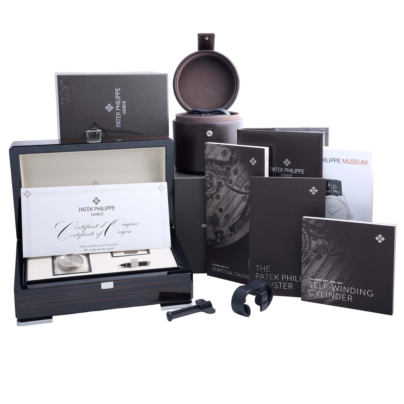 The image shows a Patek Philippe Complications 5320G-001 Men's Yellow Gold White Dial model box set with manuals, a certificate, and accessories from a frontal angle.