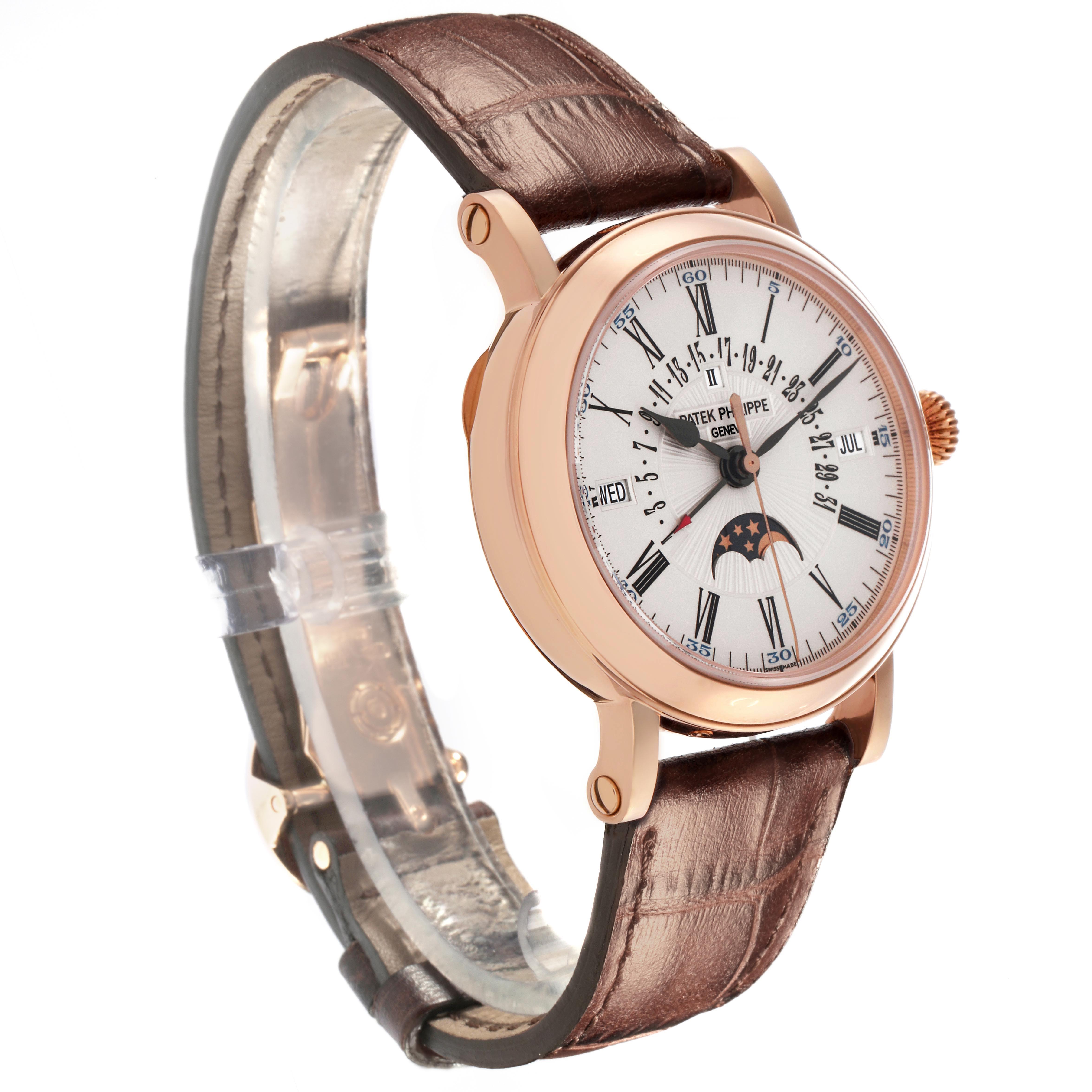 The Patek Philippe Complications 5159R Men's Rose Gold White Dial watch is shown at an angle highlighting the face, rose gold case, and brown leather strap.