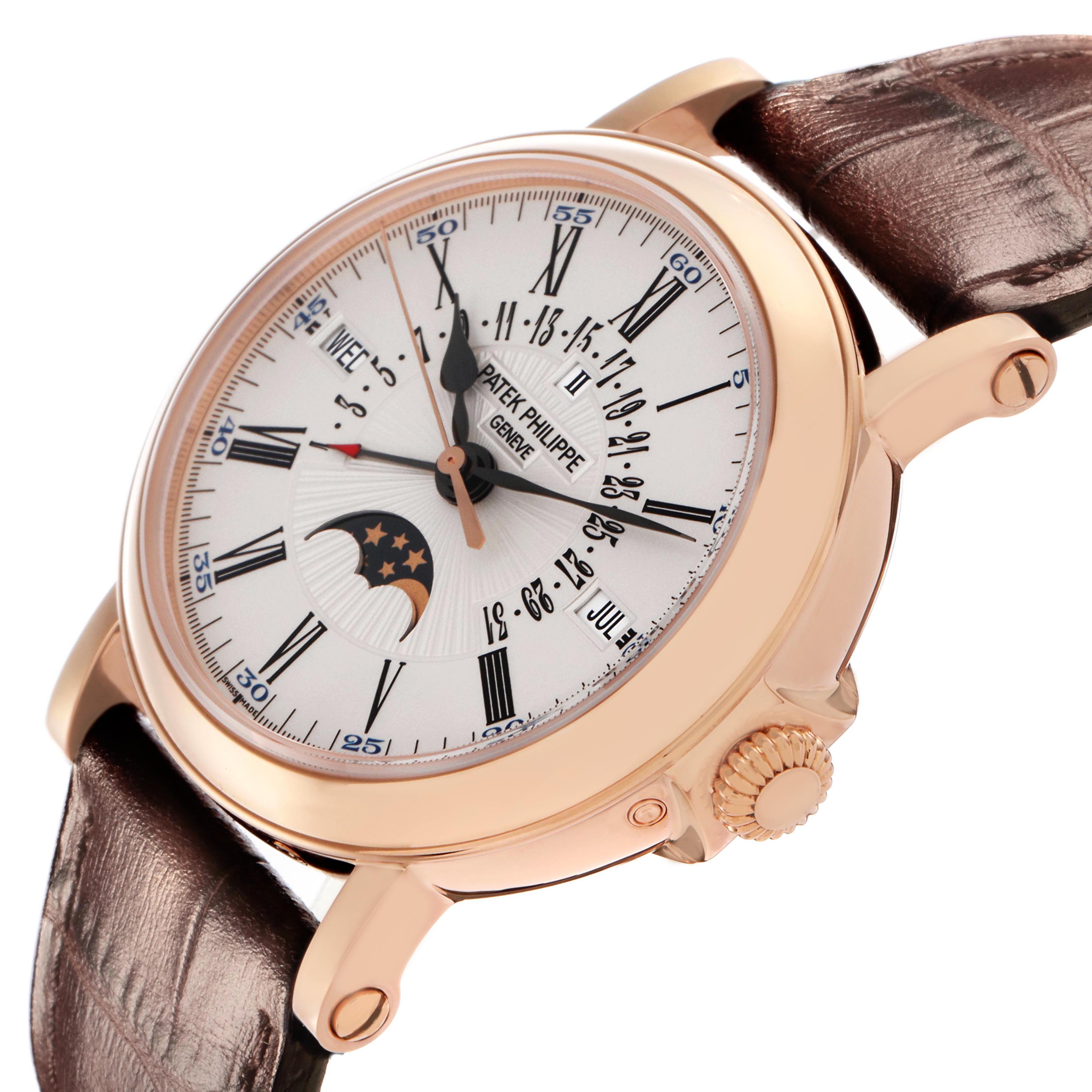 The Patek Philippe Complications 5159R Men's Rose Gold White Dial watch is shown at an angle highlighting the dial, side, crown, and leather strap.