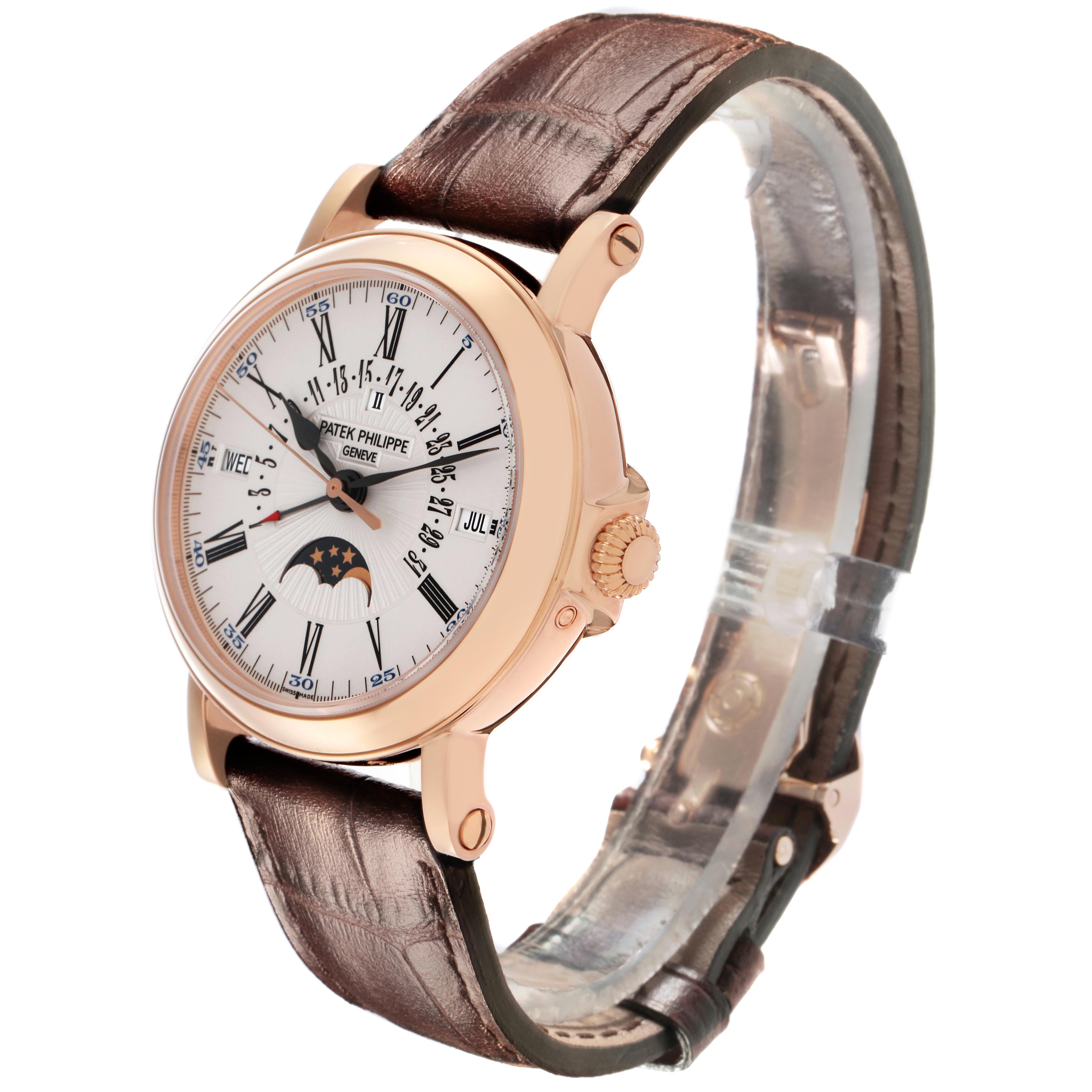 The Patek Philippe Complications 5159R Men's Rose Gold White Dial watch is shown at a three-quarter angle, highlighting the face, case, crown, and leather strap.