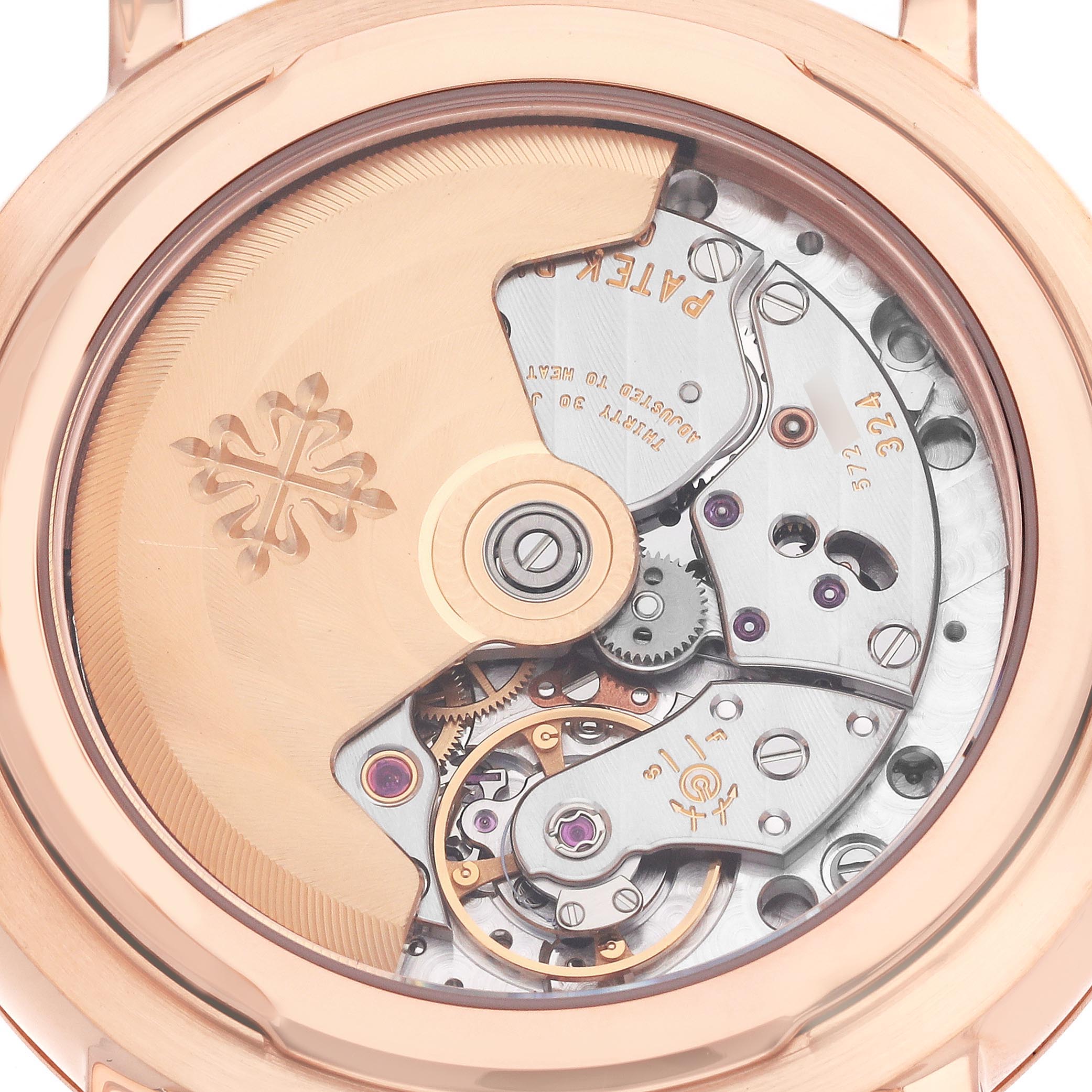 The image shows the back view of a Patek Philippe Complications 5159J-001 Men's Rose Gold White Dial 5159J-001 Men's Rose Gold White Dial watch, displaying its intricate mechanical movement and rotor.
