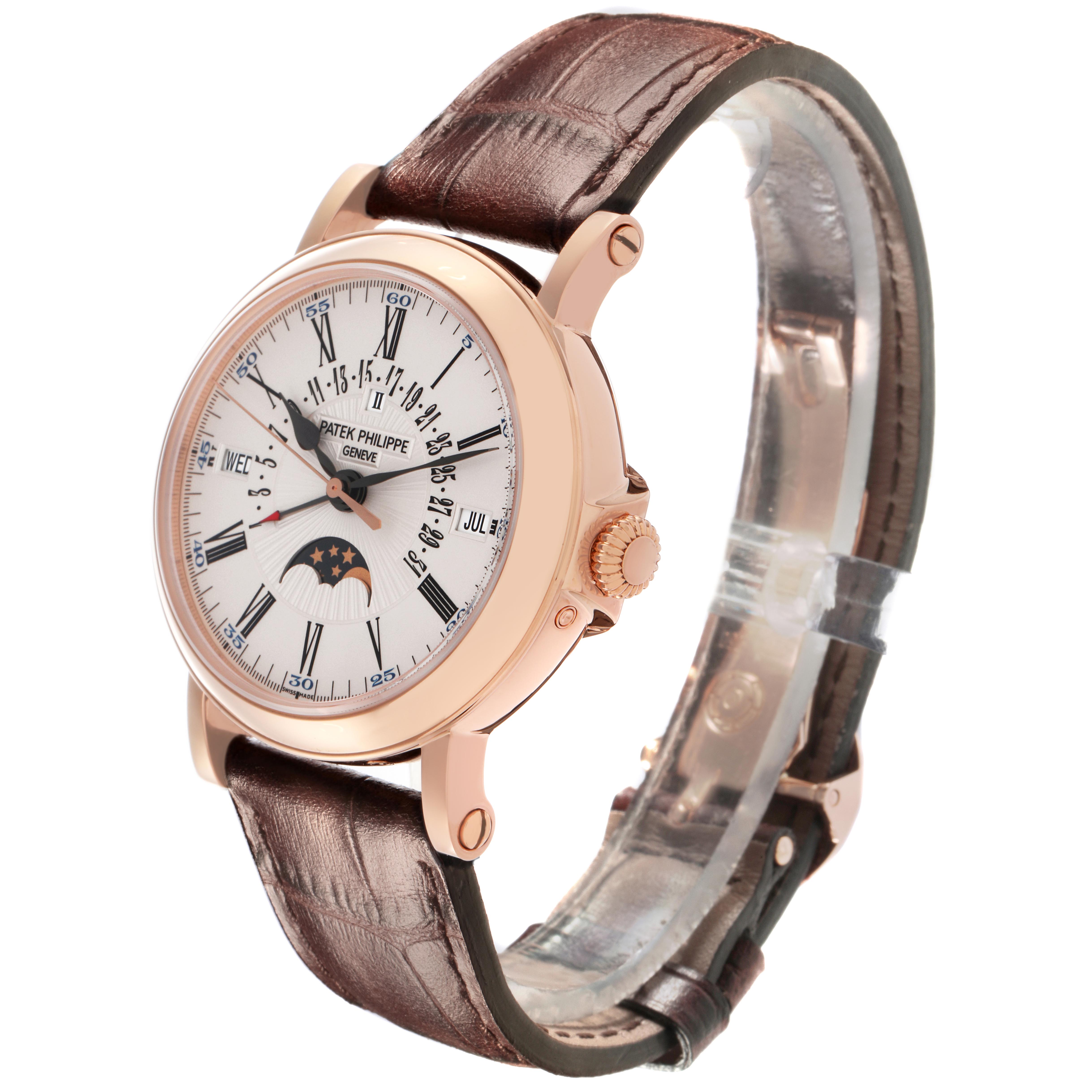 The Patek Philippe Complications 5159J-001 Men's Rose Gold White Dial 5159J-001 Men's Rose Gold White Dial watch is shown at a three-quarter angle, displaying the dial, crown, and leather strap.