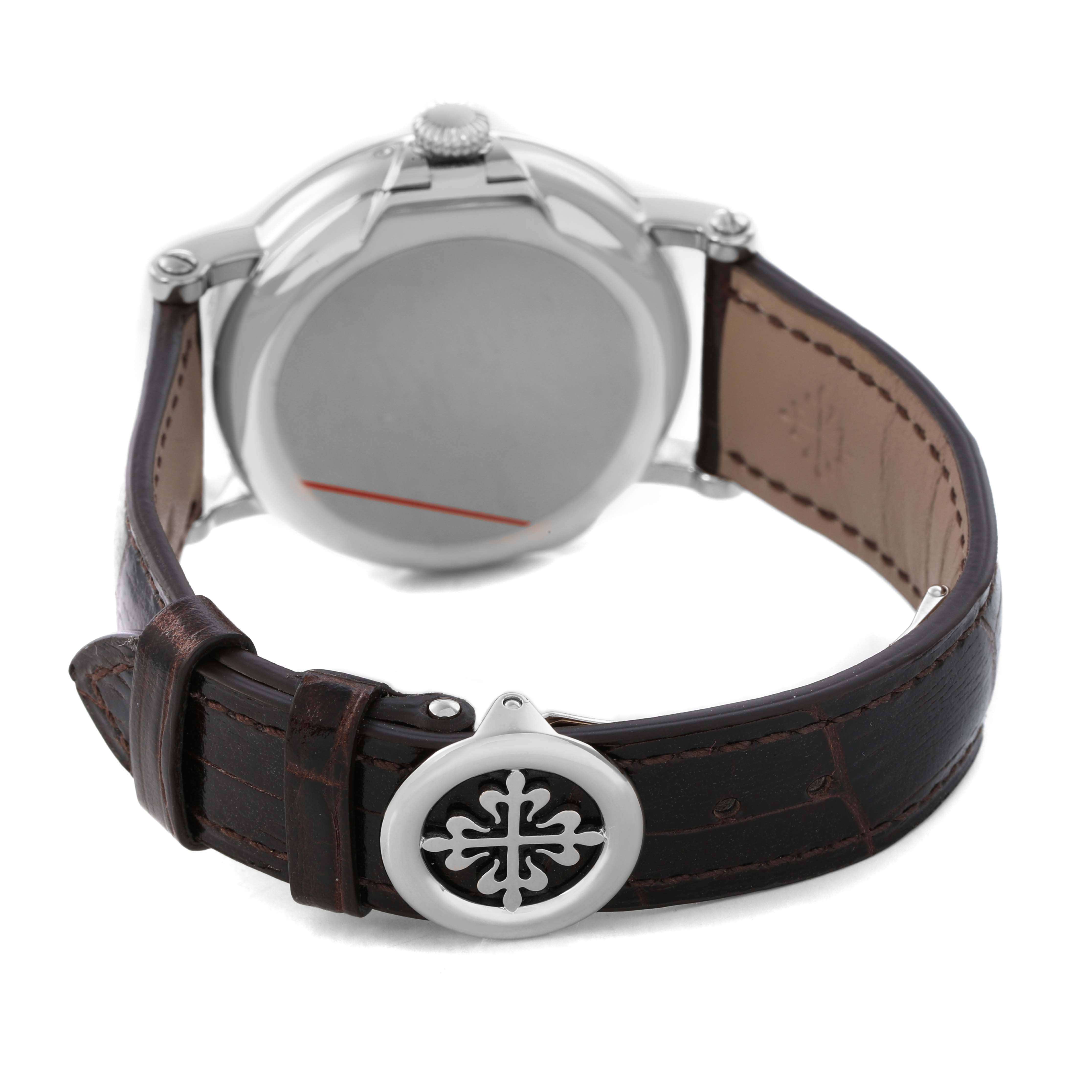 The Patek Philippe Complications 5159G-001 Men's White Gold Silver Dial watch is shown from the back, highlighting the caseback, crown, and leather strap with a clasp.