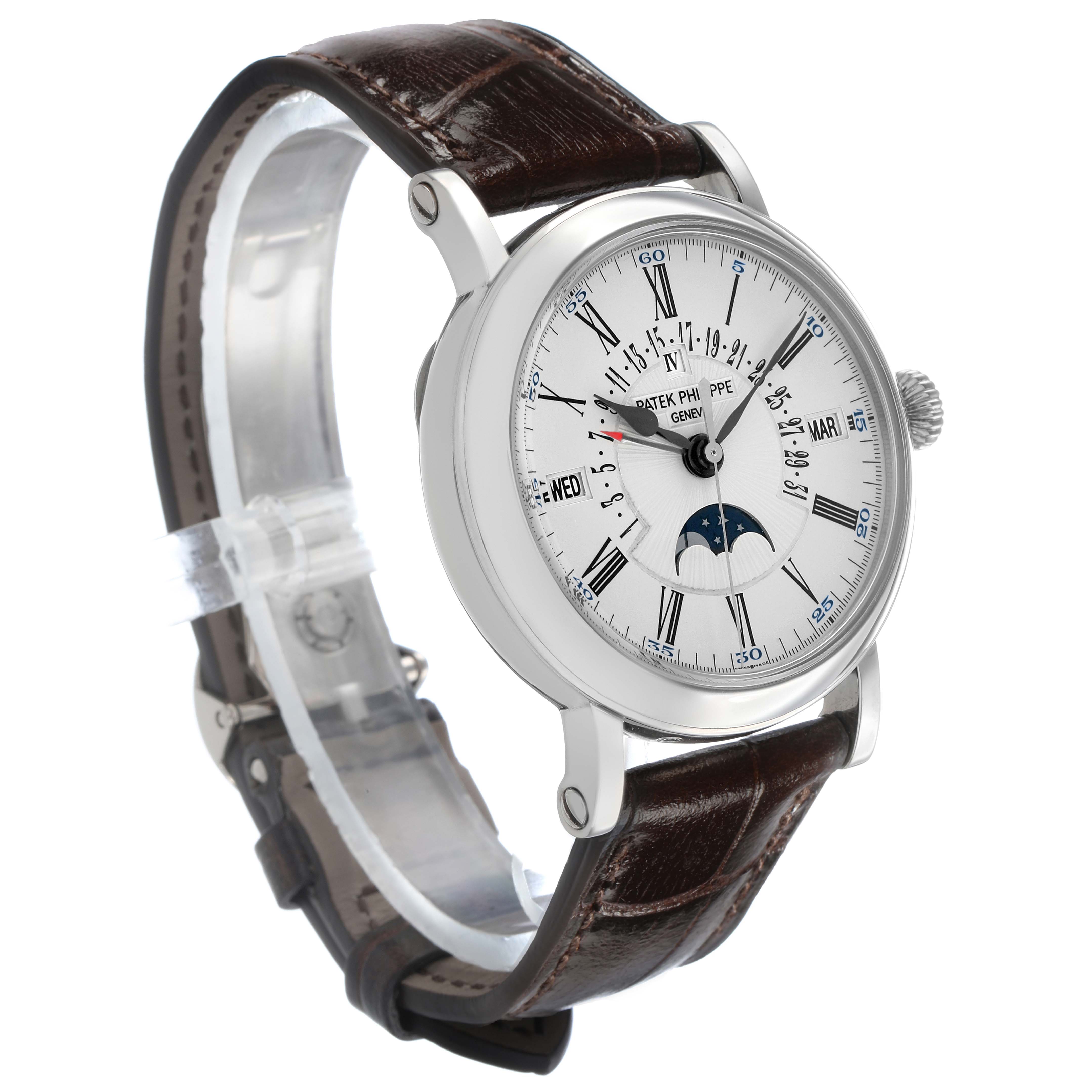 The Patek Philippe Complications 5159G-001 Men's White Gold Silver Dial watch is shown at an angled side view, displaying the dial, strap, and crown.