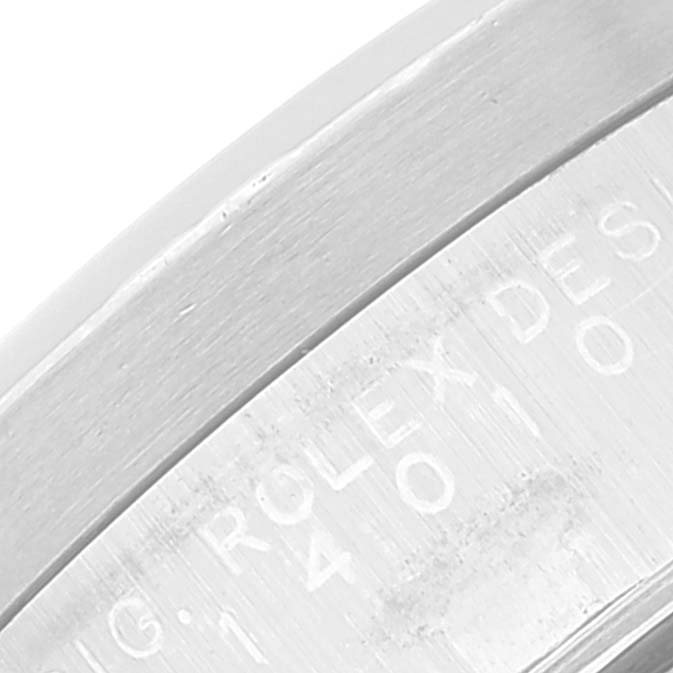The image shows a close-up of the side engraving on a Rolex Air-King 14010 Men's Stainless Steel Black Dial 14010 Men's Stainless Steel Black Dial watch, featuring the word "ROLEX" and part of the model number.