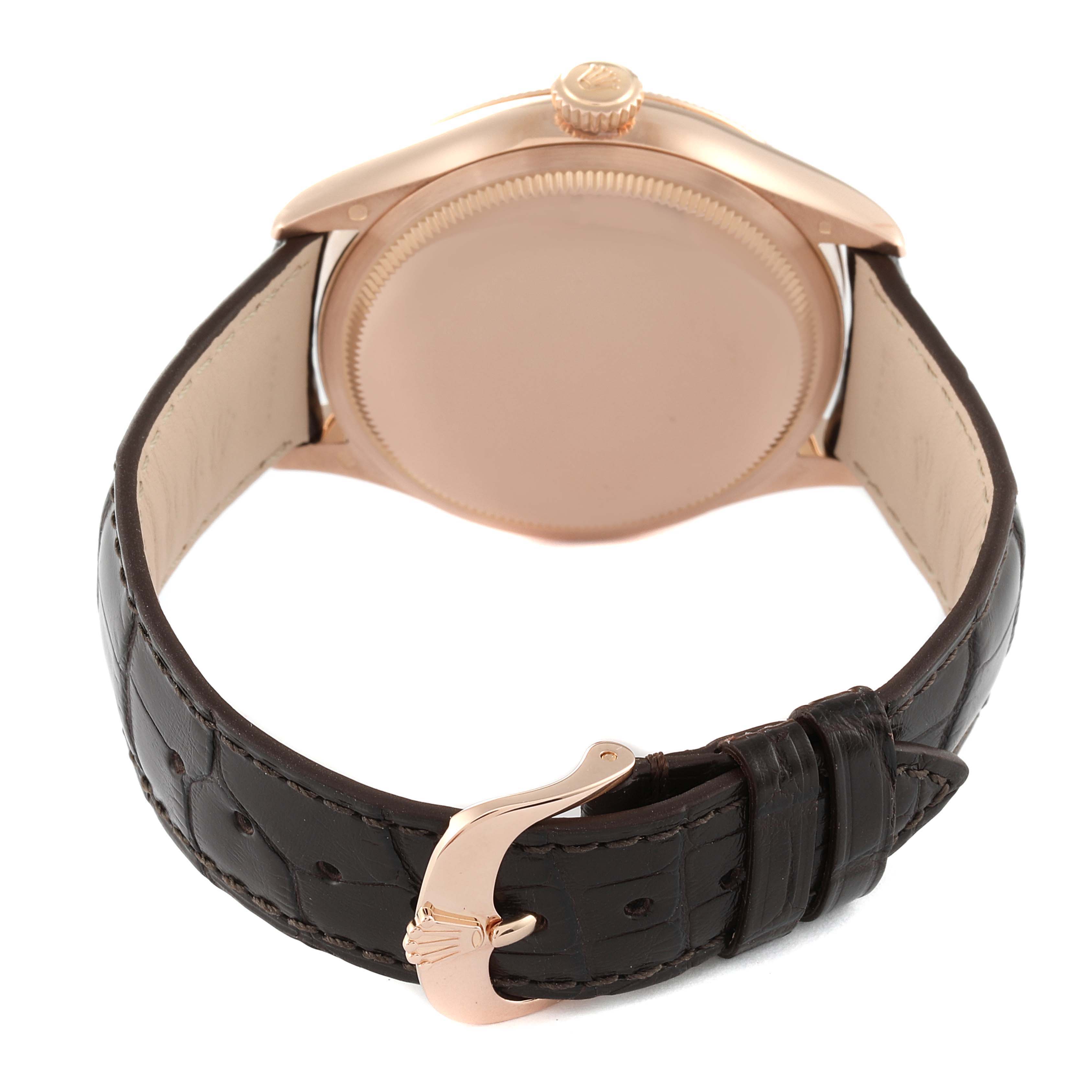 The image shows the backside of a Rolex Cellini 50505 Men's Rose Gold White Dial 50505 Men's Rose Gold White Dial watch, including the case and the leather strap with a clasp.