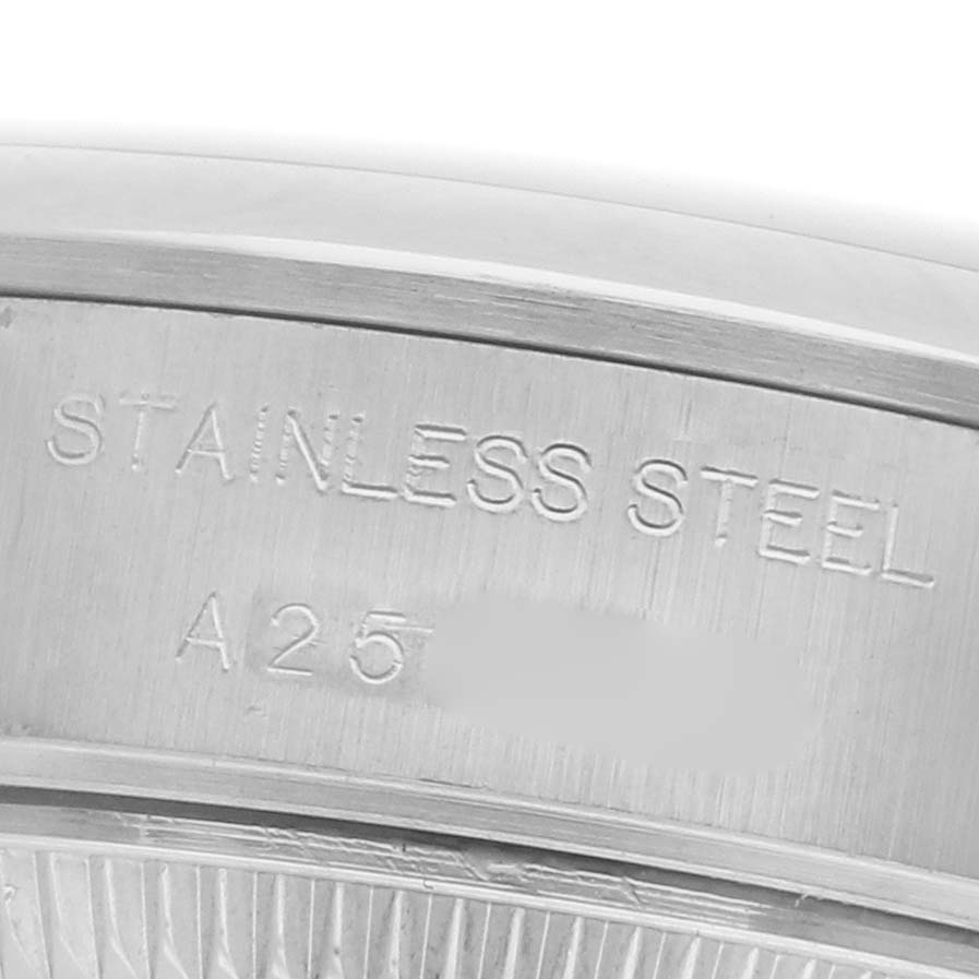 The image shows a close-up of the casing or bezel engraving on a Rolex Date 79160 Women's Stainless Steel Pink Dial 79160 Women's Stainless Steel Pink Dial model, highlighting "Stainless Steel."
