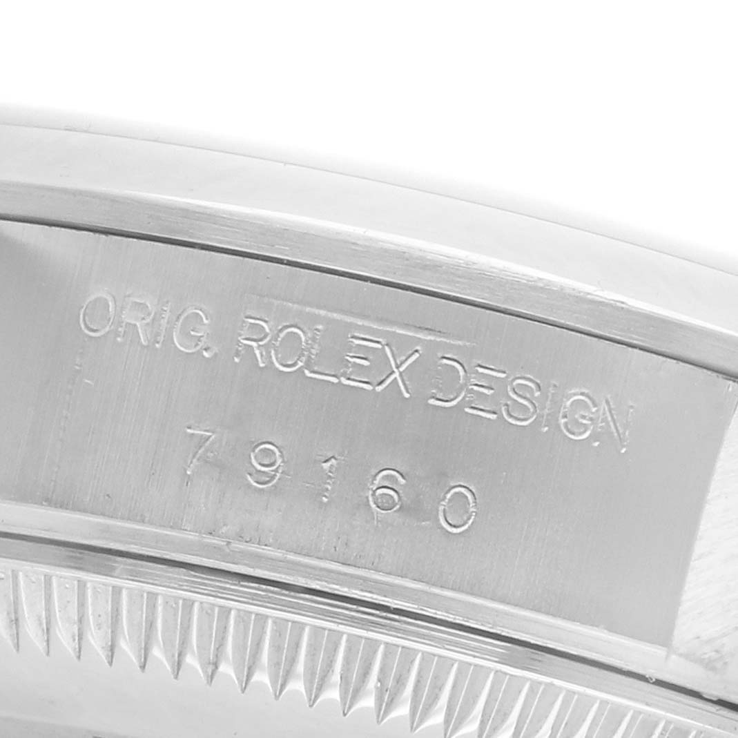 The image shows the side of a Rolex Date 79160 Women's Stainless Steel Pink Dial 79160 Women's Stainless Steel Pink Dial model case with engravings, viewed at a close angle.
