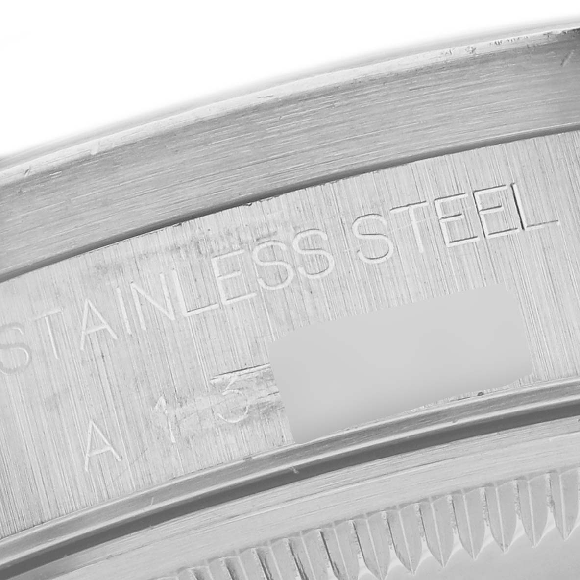 This image shows a close-up view of the inscription on the inner case of a Rolex Date 15210 Men
s Stainless Steel Black Dial 15210 Men
s Stainless Steel Black Dial model watch, highlighting "STAINLESS STEEL."