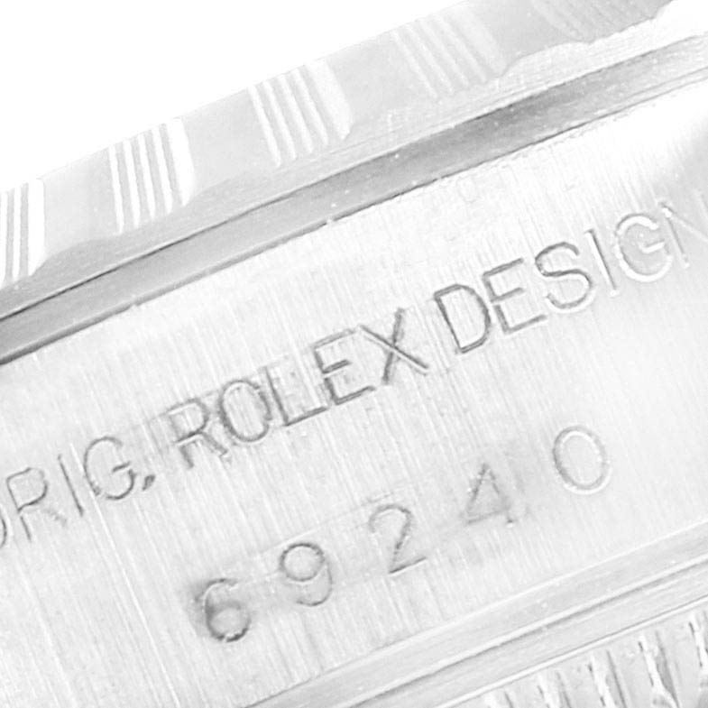 This close-up image shows the inner engraving on the case of a Rolex Date 69240 Women
s Stainless Steel Blue Dial 69240 Women
s Stainless Steel Blue Dial model, displaying the serial number and "ROLEX DESIGN" text.
