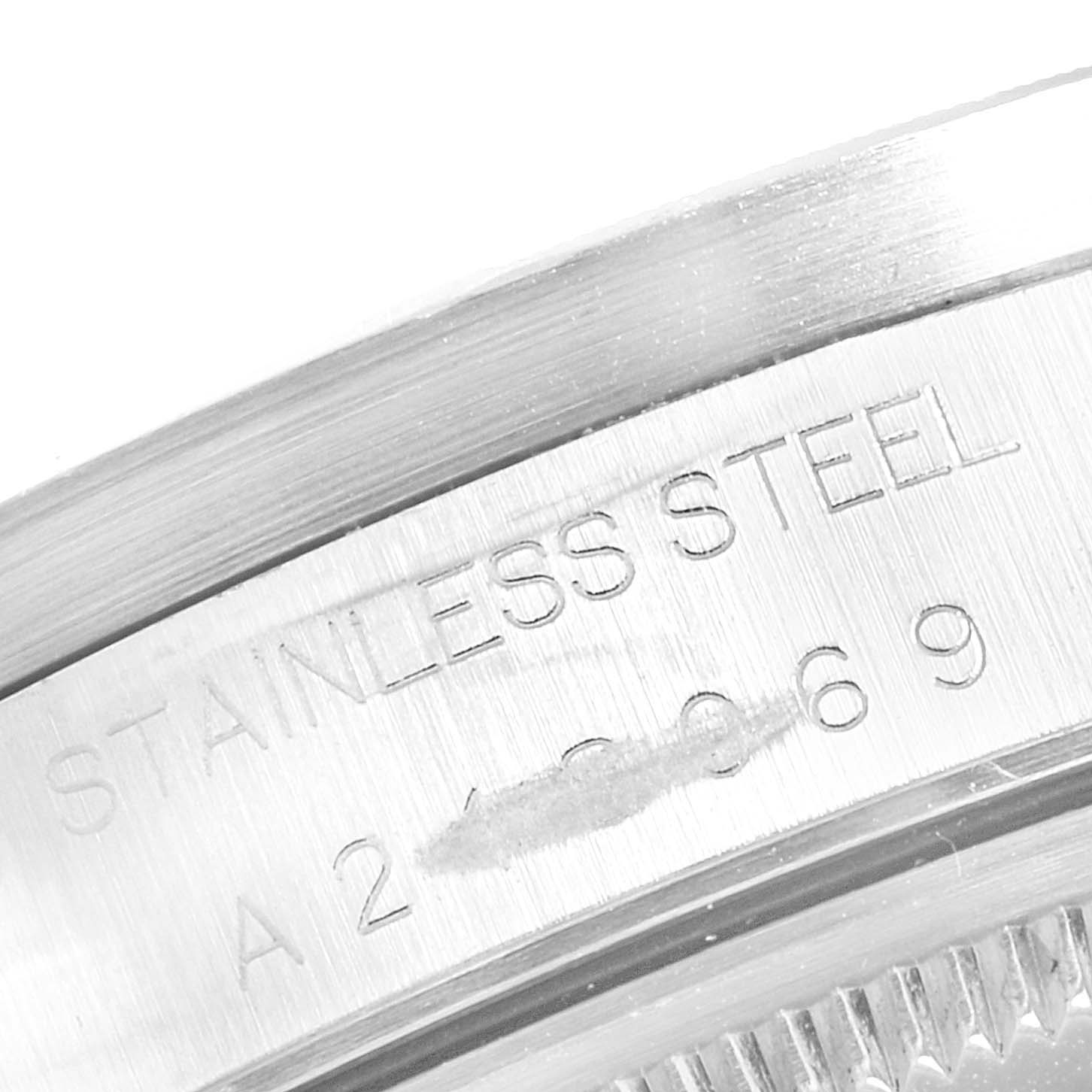 This image shows a close-up of the serial number and stainless steel engraving on the case of a Rolex Date 15210 Men's Stainless Steel Silver Dial 15210 Men's Stainless Steel Silver Dial model.