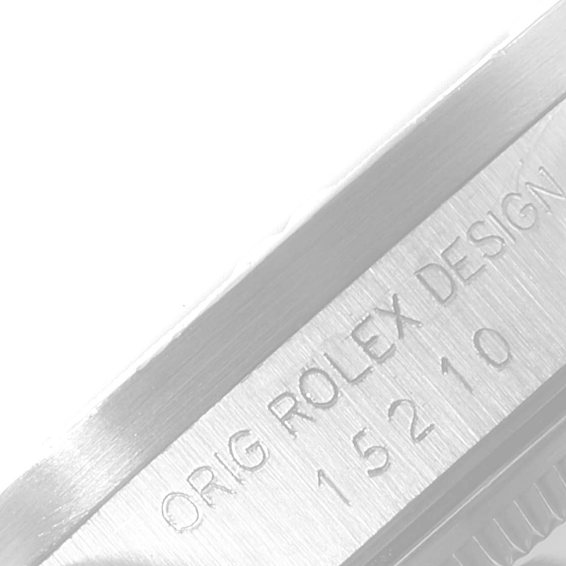 The image shows a close-up of the case side of a Rolex Date 15210 Men's Stainless Steel Silver Dial 15210 Men's Stainless Steel Silver Dial model, highlighting the engraved model number and "ORIG ROLEX DESIGN" text.