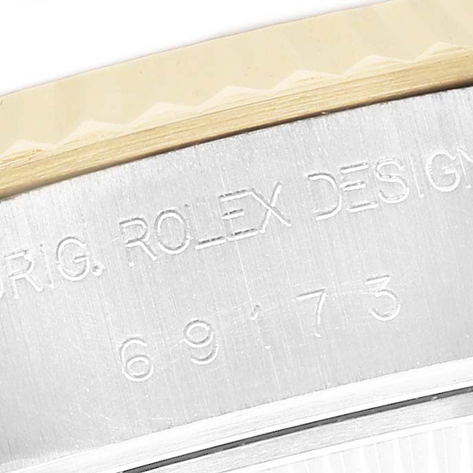 The image shows an angled close-up of the side of a Rolex Datejust 69173 Men's Steel and Gold (two tone) Champagne Dial watch, focusing on the engraved model and design number.