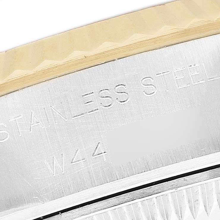 The image shows a close-up of the side of a Rolex Datejust 69173 Men's Steel and Gold (two tone) Champagne Dial, highlighting the stainless steel part and engraving.