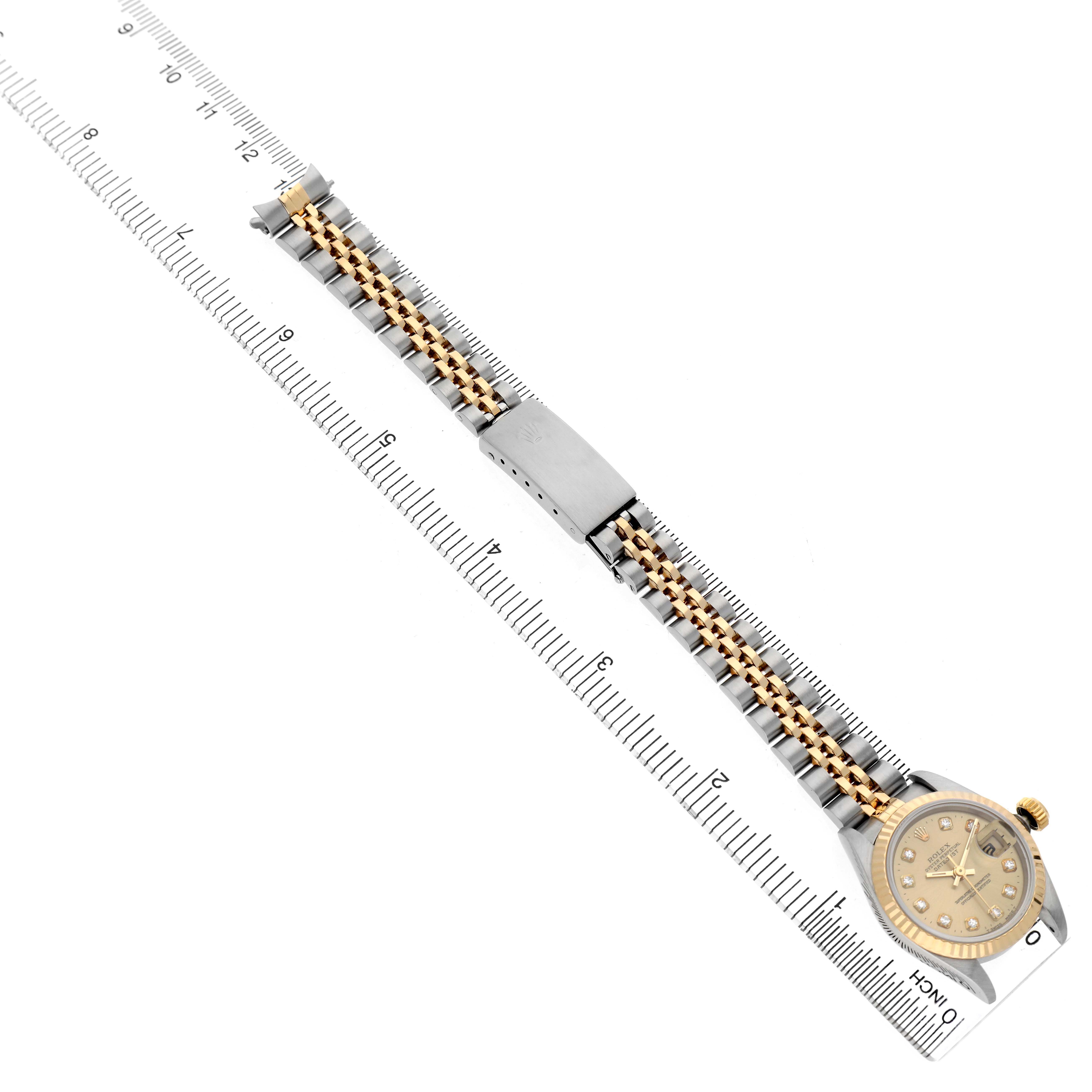 The image shows the Rolex Datejust 69173 Men's Steel and Gold (two tone) Champagne Dial watch lying flat with a clear view of the bracelet and clasp, aligned with a ruler.