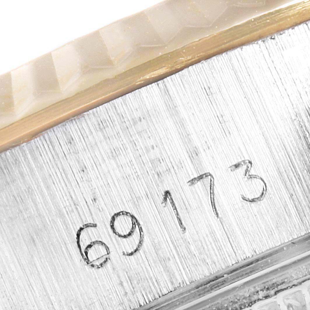 This image shows a close-up of a serial number engraved on the side of a Rolex Datejust 69173 Women's Steel and Gold (two tone) Champagne Dial 69173 Women's Steel and Gold (two tone) Champagne Dial watch case.