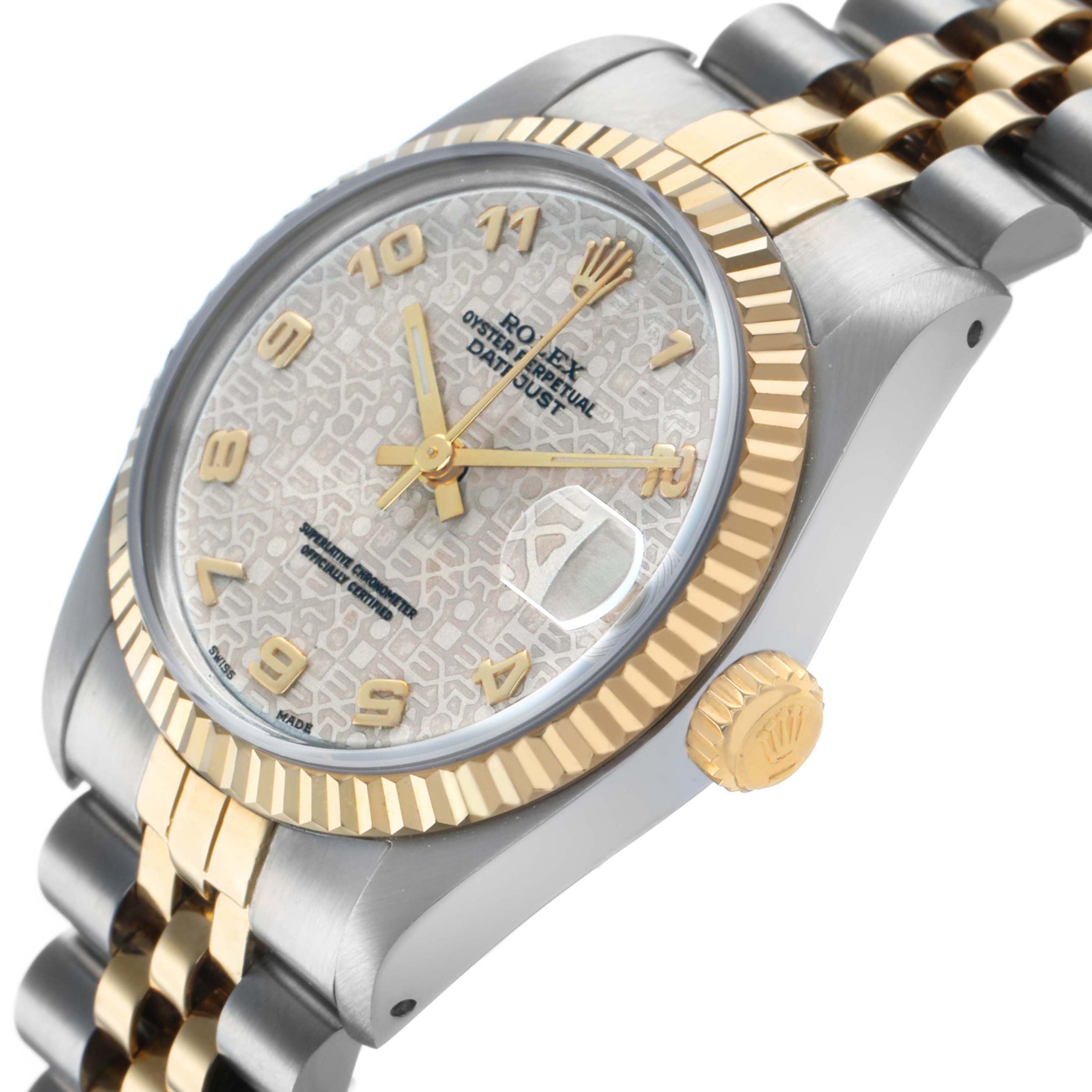 The image displays a side view of the Mid-Size Rolex watch, highlighting the bezel, crown, and partial bracelet.