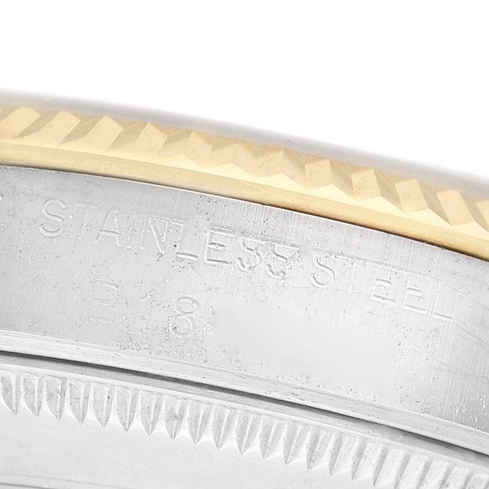 The image shows a close-up of the Rolex Mid-Size 68273 Women's Steel and Gold (two tone) White Dial watch's stainless steel case edge and fluted bezel.