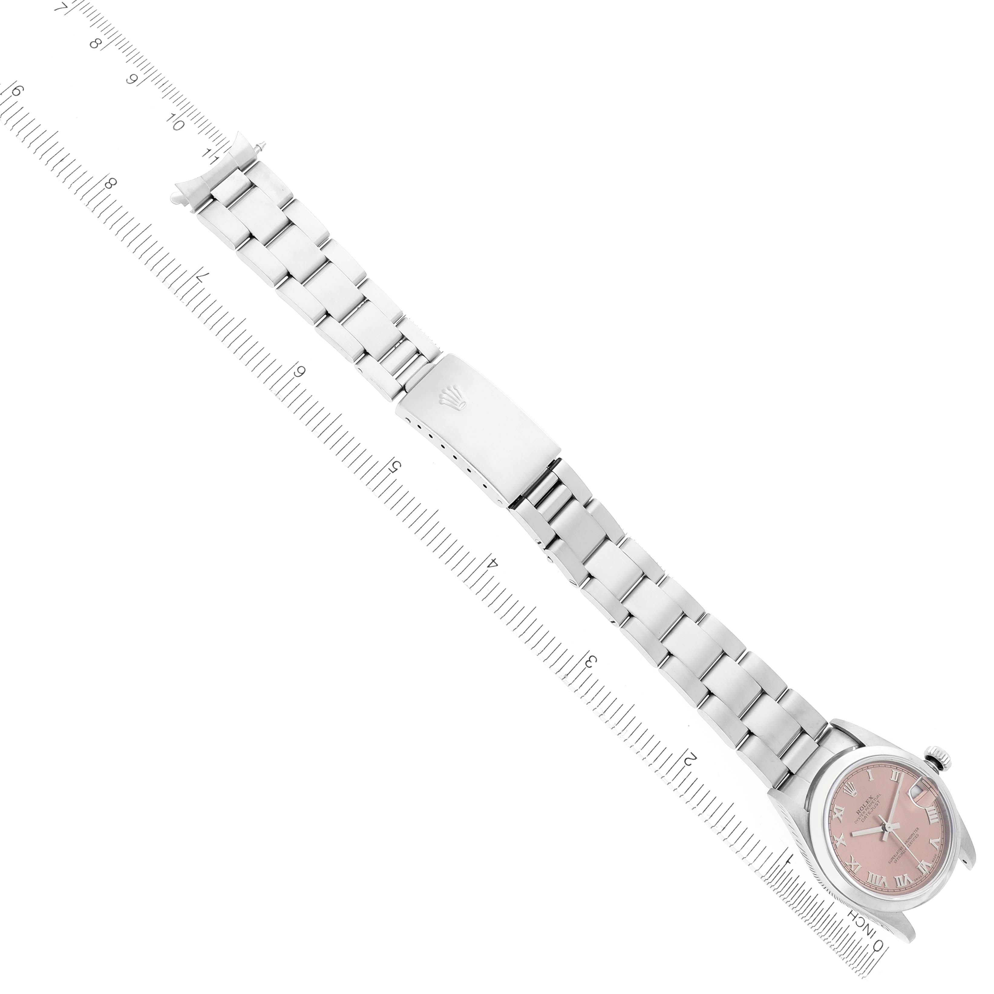The Rolex Mid-Size 78240 Women's Stainless Steel Pink Dial 78240 Women's Stainless Steel Pink Dial watch is shown from an angled top view, displaying the bracelet, clasp, and face beside a measuring ruler.