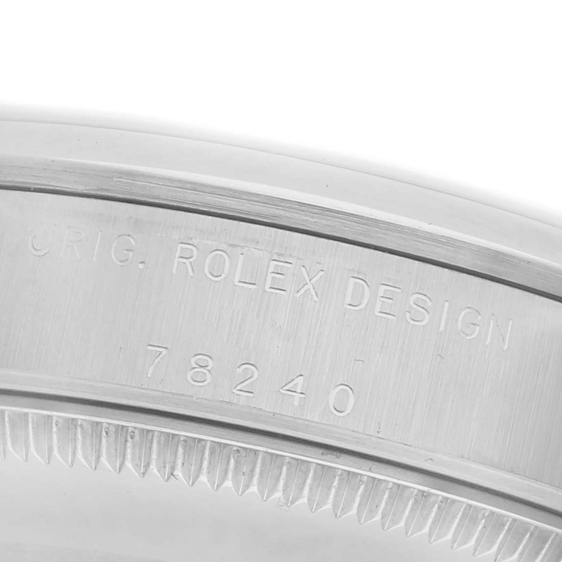 The image shows the engraved side of a Rolex Mid-Size 78240 Women's Stainless Steel Pink Dial 78240 Women's Stainless Steel Pink Dial model, highlighting the serial and design details.