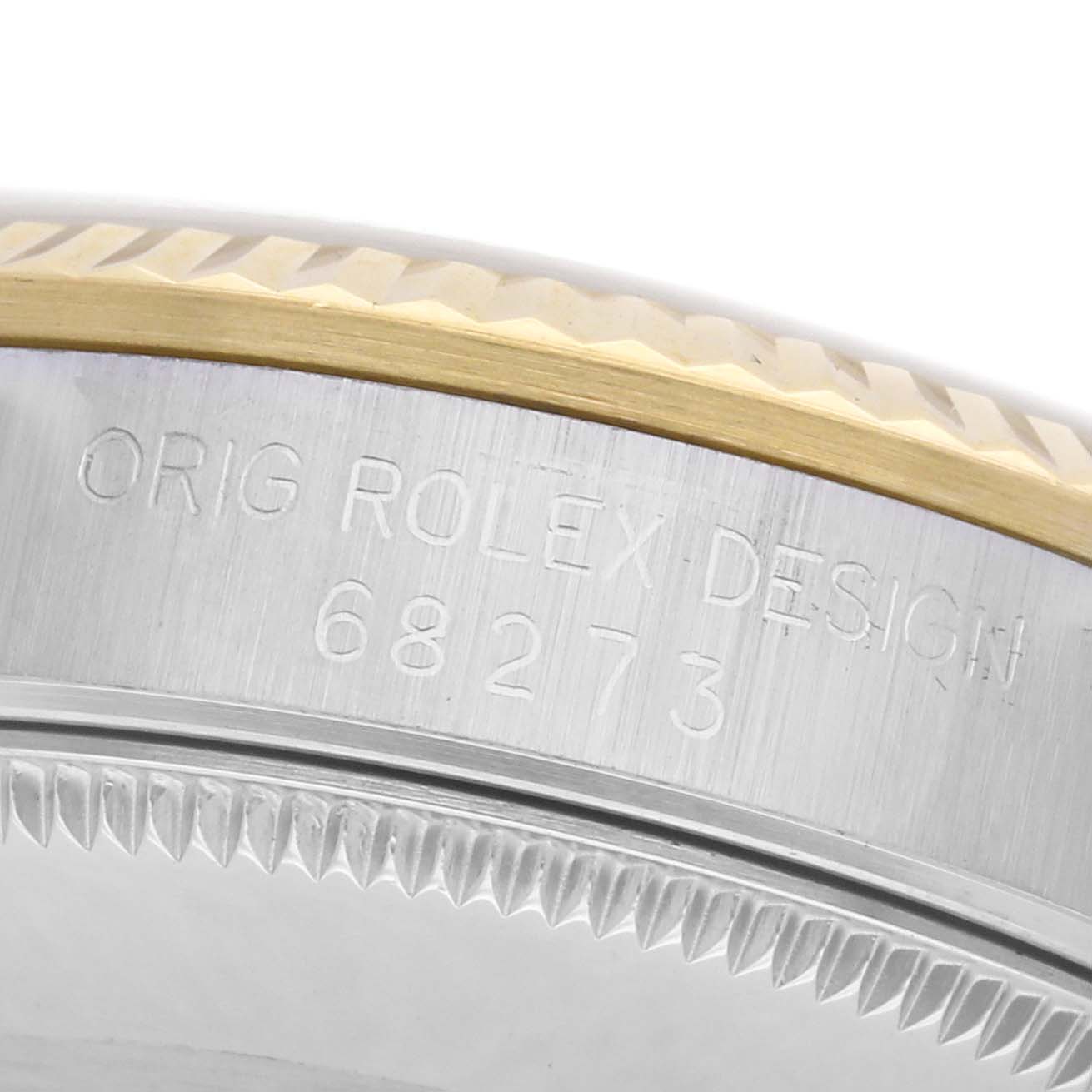 The image shows the side of a Rolex Mid-Size 68273 Women's Steel and Gold (two tone) Champagne Dial 68273 Women's Steel and Gold (two tone) Champagne Dial watch, focusing on the engraved model number and part of the bezel.