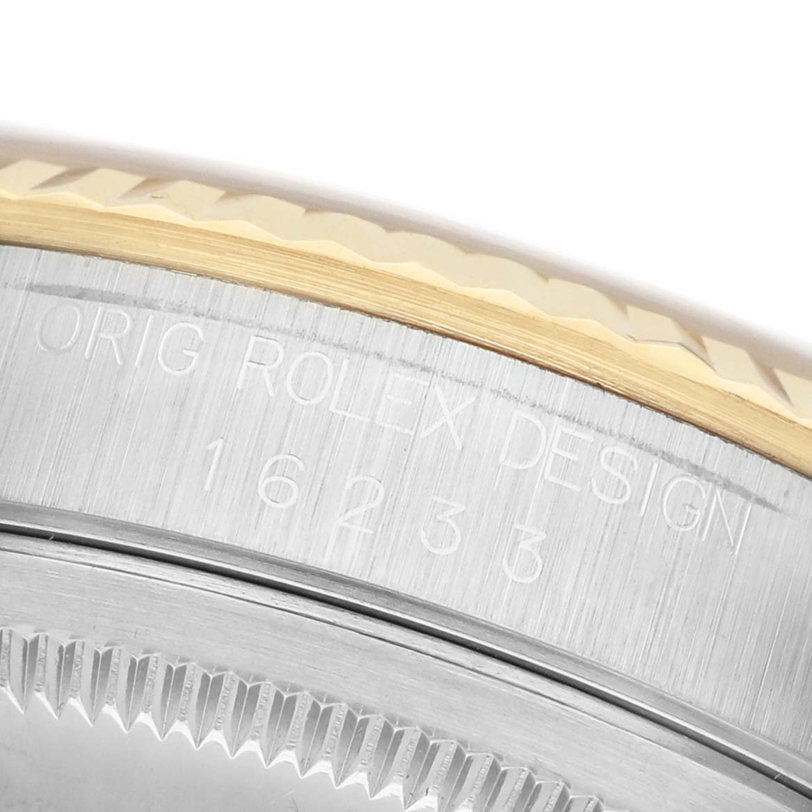 The image shows a close-up of the Rolex Datejust 16233 Men's Steel and Gold (two tone) Champagne Dial bezel and case side, highlighting the model engraving and fluted design.